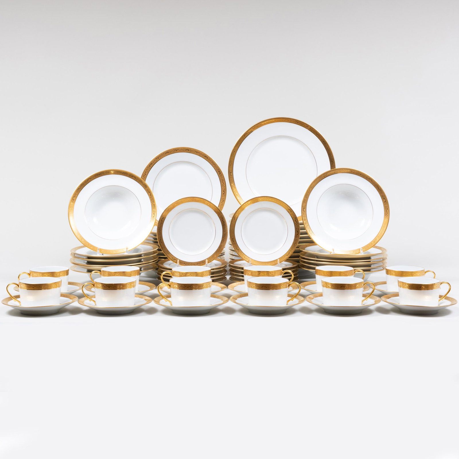 Reynaud Limoges Porcelain Gilt-Decorated Part Service: Reynaud Limoges Porcelain Gilt-Decorated Part Service Blue and green printed mark. Comprising: Twelve dinner plates Twelve lunch plates Twelve side plates Twelve cups and saucers The dinner plates 10 
