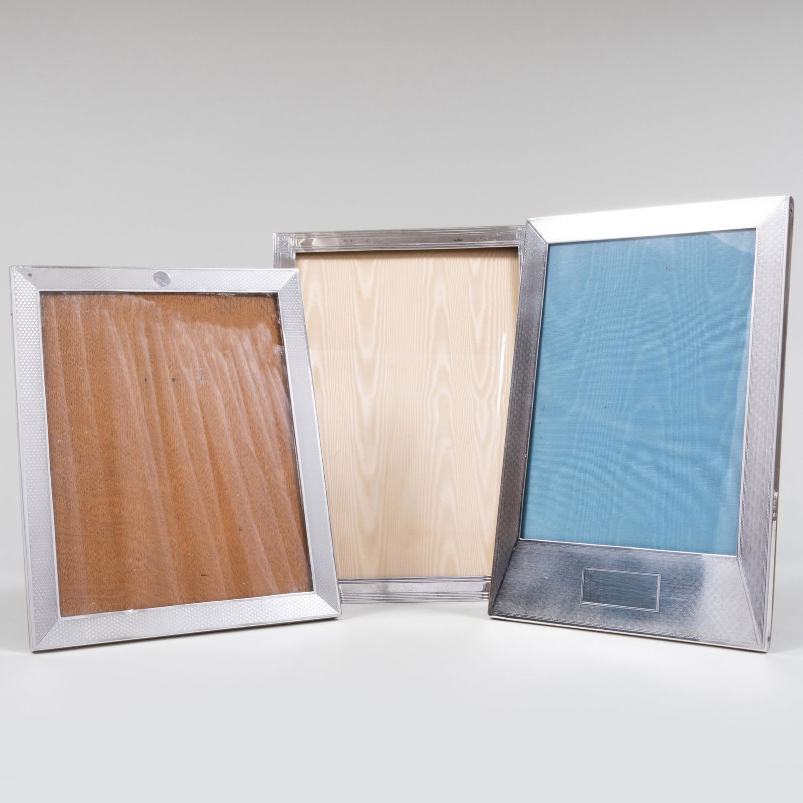 Group of Silver Picture Frames: Group of Silver Picture Frames Comprising: A Tiffany & Co. silver frame, marked 'Sterling' An English silver frame, marked Birmingham An English silver frame, marked Birmingham The largest 12 3/4 x 9