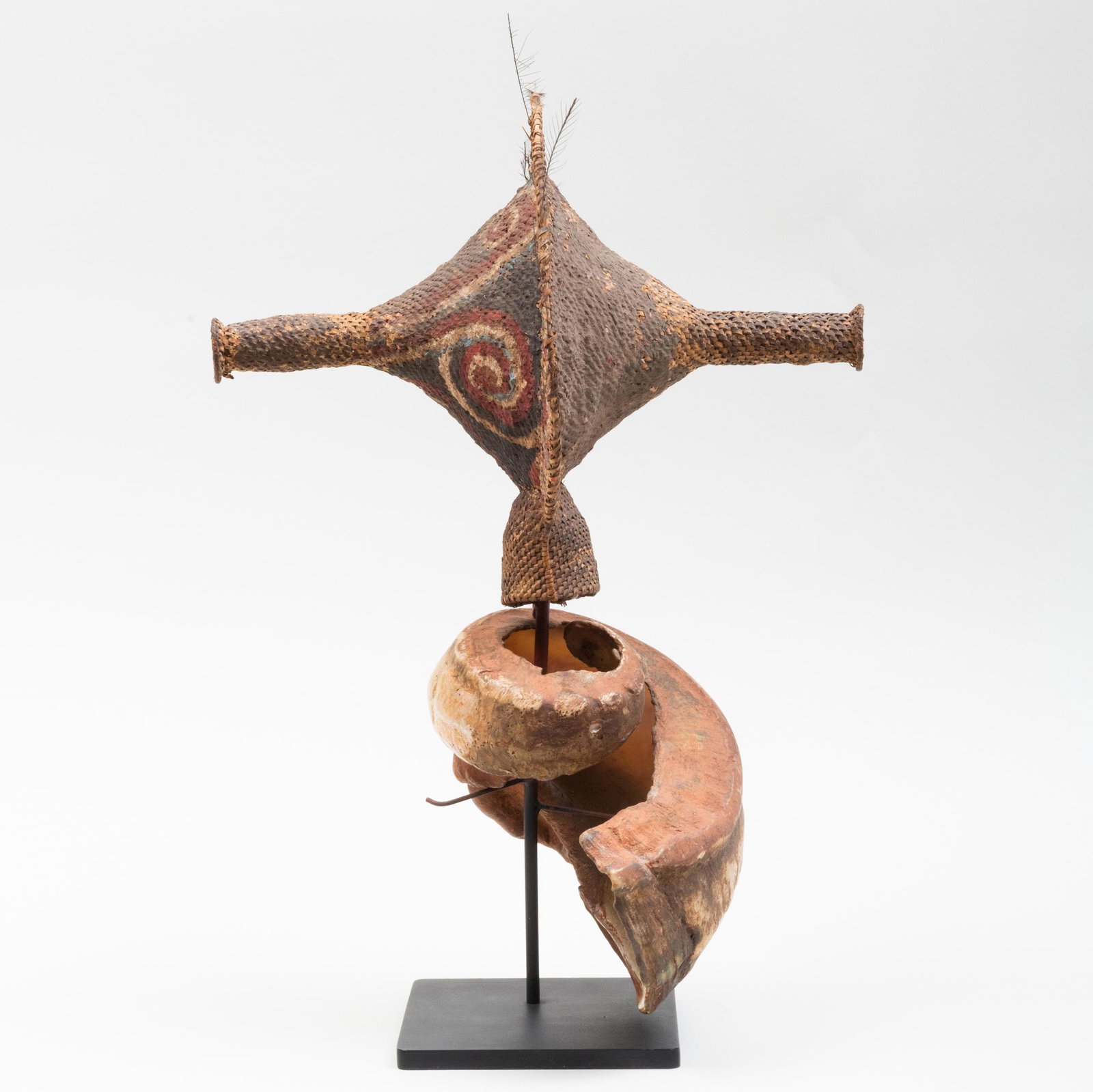 Boiken Shell Currency, 'Talipoon', Papua New Guinea: Boiken Shell Currency, 'Talipoon', Papua New Guinea Shell, plaited fiber, clay, feathers, pigments. 17 1/2 x 8 1/2 x 11 3/4 in. (overall). Joel Cooner Gallery, Dallas, TX. Property from the Est