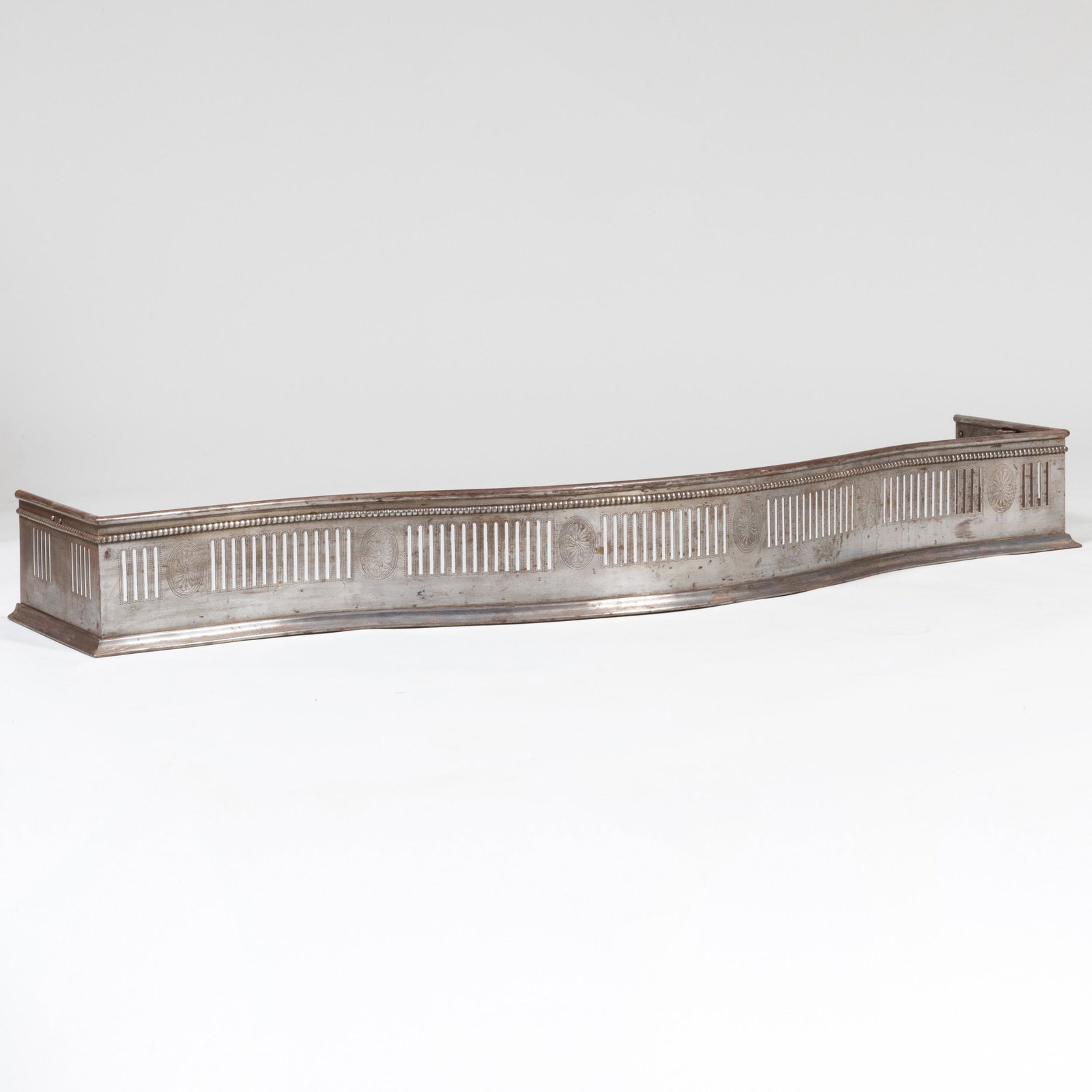 Steel Serpentine-Front Fireplace Fender and a Brass Fireplace Fender with Lion Masks: Steel Serpentine-Front Fireplace Fender and a Brass Fireplace Fender with Lion Masks 7 1/4 x 5 ft. 3 in. x 15 in. and 8 1/2 x 42 x 12 1/2 in.