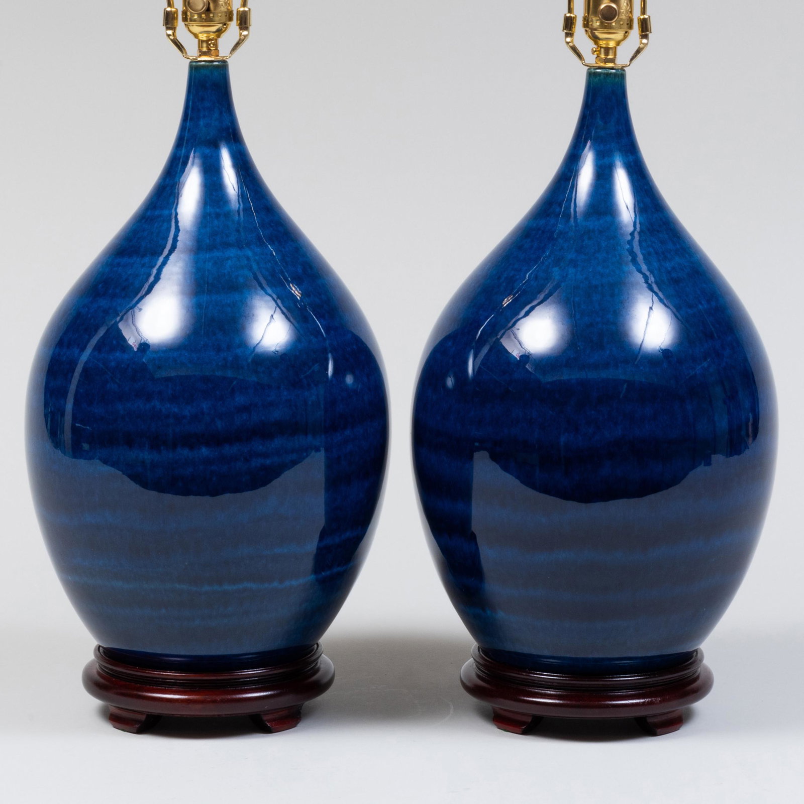 Pair of Contemporary Blue-Glazed Porcelain Teardrop Form Vases, Mounted as Table Lamps: Pair of Contemporary Blue-Glazed Porcelain Teardrop Form Vases, Mounted as Table Lamps 27 1/2 x 9 in. diam. (to top of harp). Property from the Collection of Susan Lasker Brody