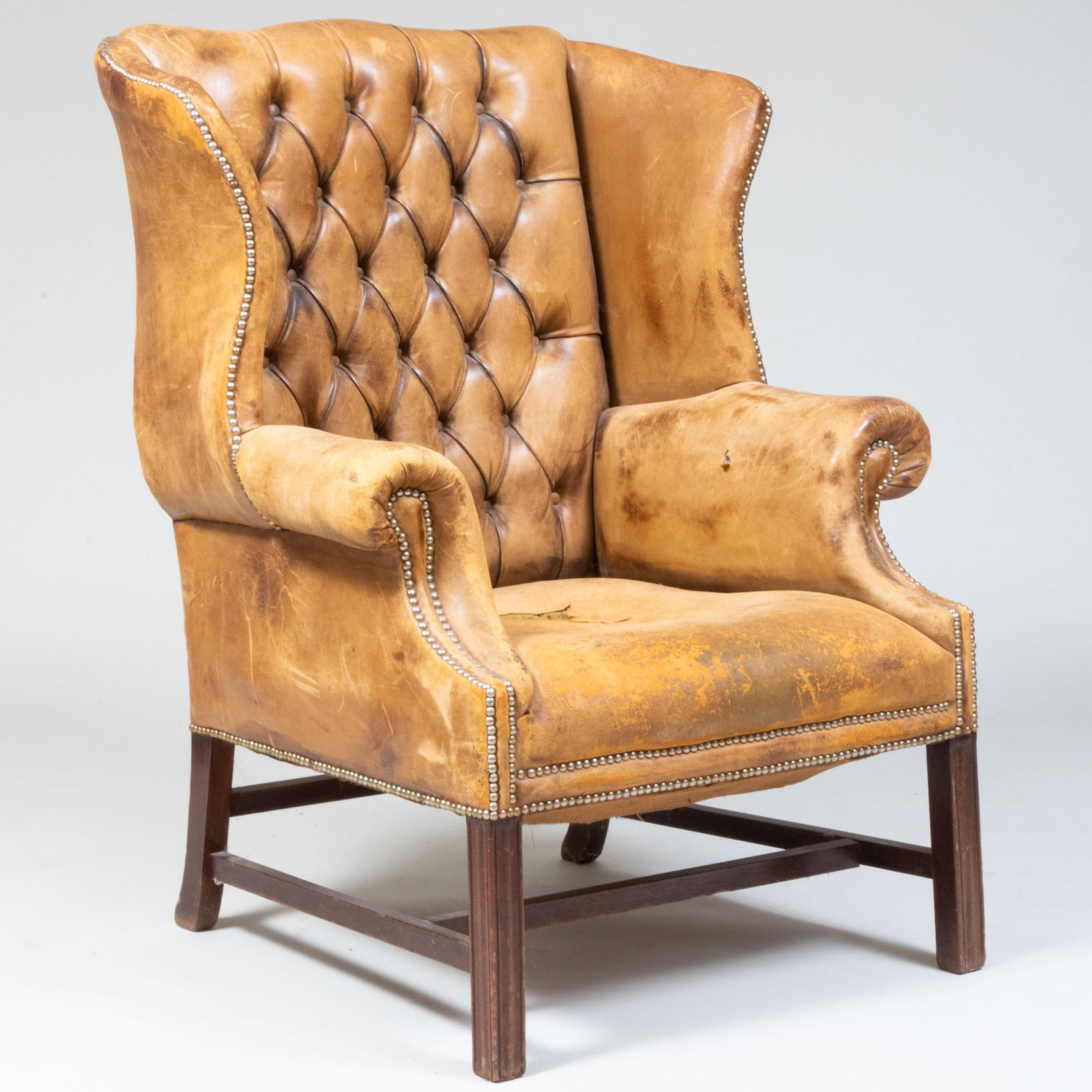 George III Style Mahogany and Tufted Leather Library Wing Chair: George III Style Mahogany and Tufted Leather Library Wing Chair 43 1/2 x 33 3/4 x 29 in., height of seat 16 1/2 in.