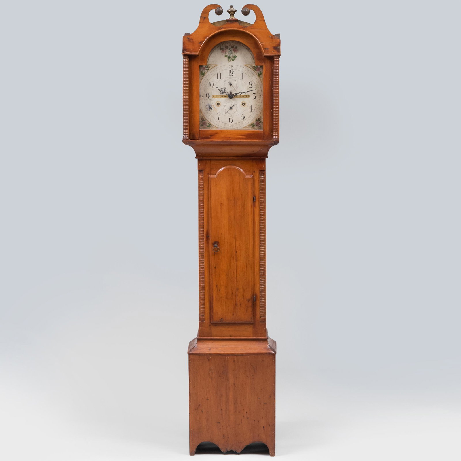 Federal Cherry Long Case Clock, New England: Federal Cherry Long Case Clock, New England The painted and enameled wood dial signed 'R. WHITING, WINCHESTER'. With wooden gears, a pendulum and two weights. 6 ft. 11 in. x 17 3/4 x 10 1/4 in. 