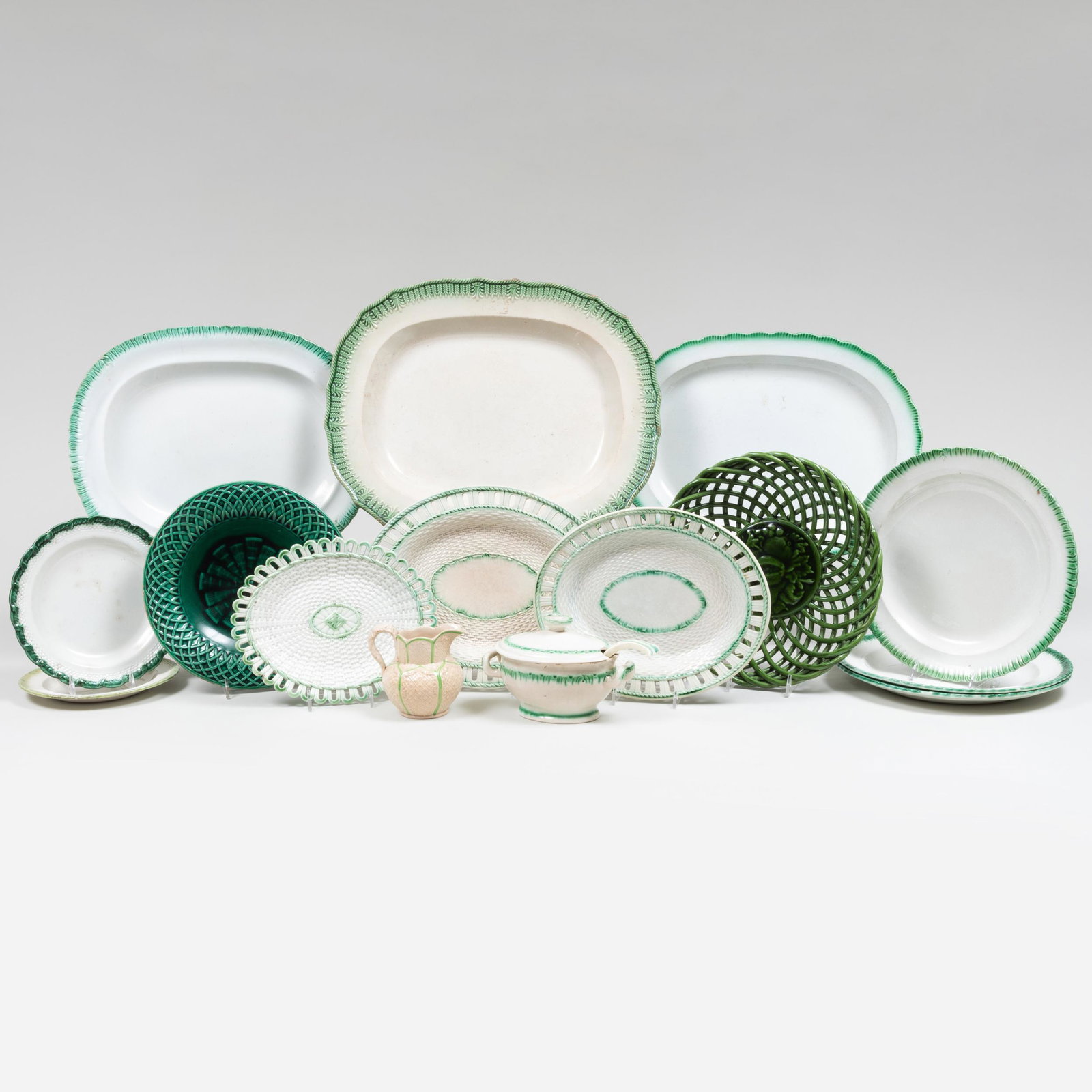 Group English Green Decorated Pearlware: Group English Green Decorated Pearlware Most unmarked. Comprising: Three platters in graduated sizes Three dinner plates, one with impressed mark for Enoch Wood Two basket weave stands, one with impre