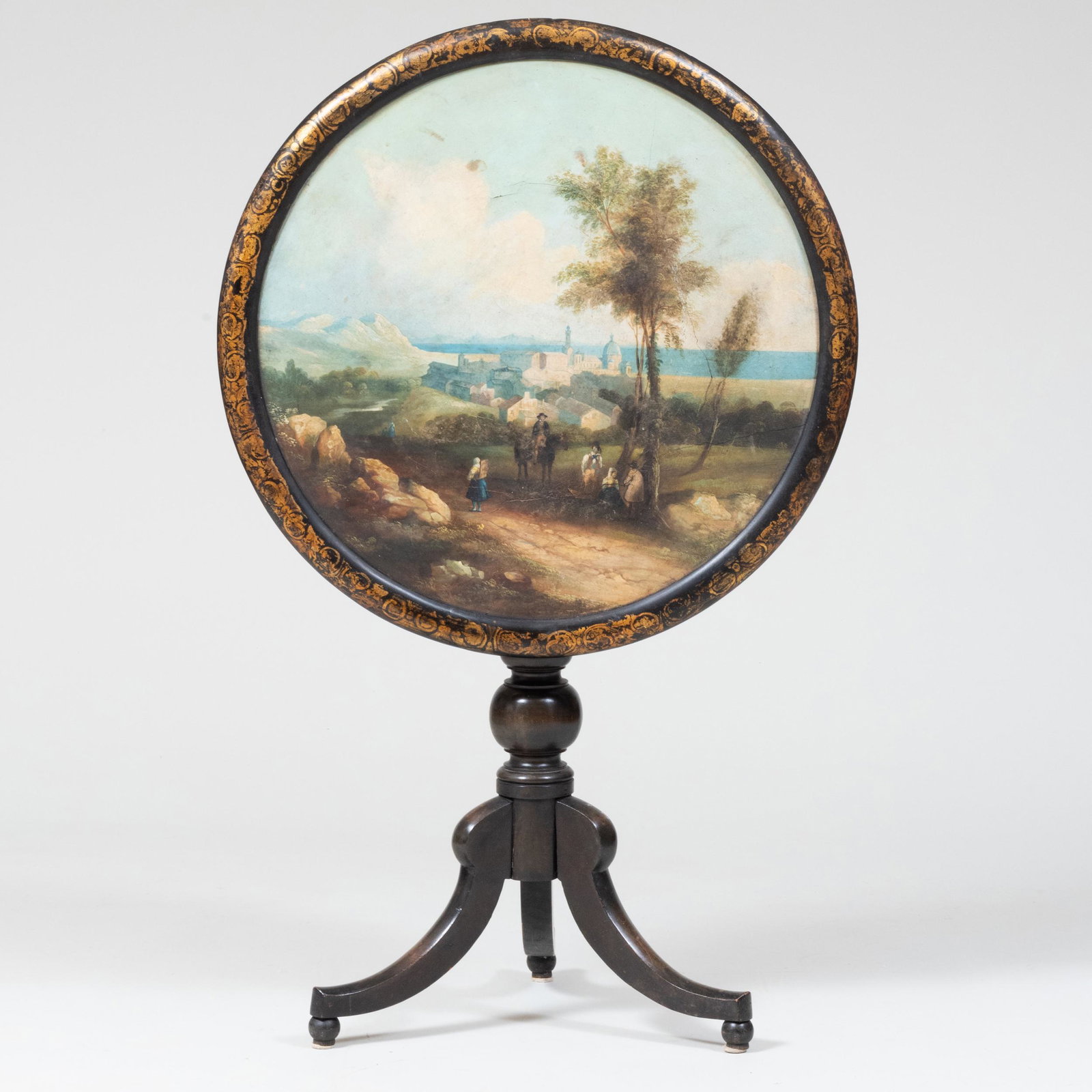 Victorian Painted Papier Maché and Ebonized Wood Tilt-Top Tripod Table: Victorian Painted Papier Maché and Ebonized Wood Tilt-Top Tripod Table The top painted with an Italianate pastoral scene. 29 1/4 x 26 3/4 in. diam.
