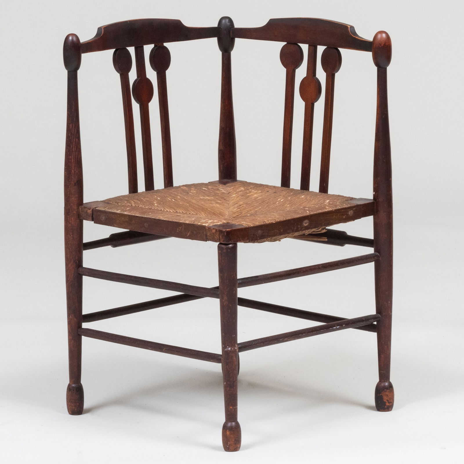 English Arts and Crafts Diminutive Stained Wood Rush Seat Corner Chair: English Arts and Crafts Diminutive Stained Wood Rush Seat Corner Chair 27 x 23 x 22 in., height of seat 14 3/4 in. Property from the Estate of Judith W. Godwin