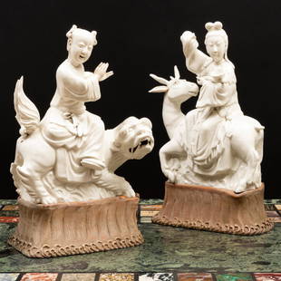 Pair of Chinese White Glazed Porcelain Figures of Immortals: Pair of Chinese White Glazed Porcelain Figures of Immortals Raised on carved wood stands. The figures 11 x 9 x 4 in., 14 x 8 1/2 x 5 in. (overall). Master Class: John Rosselli at Home