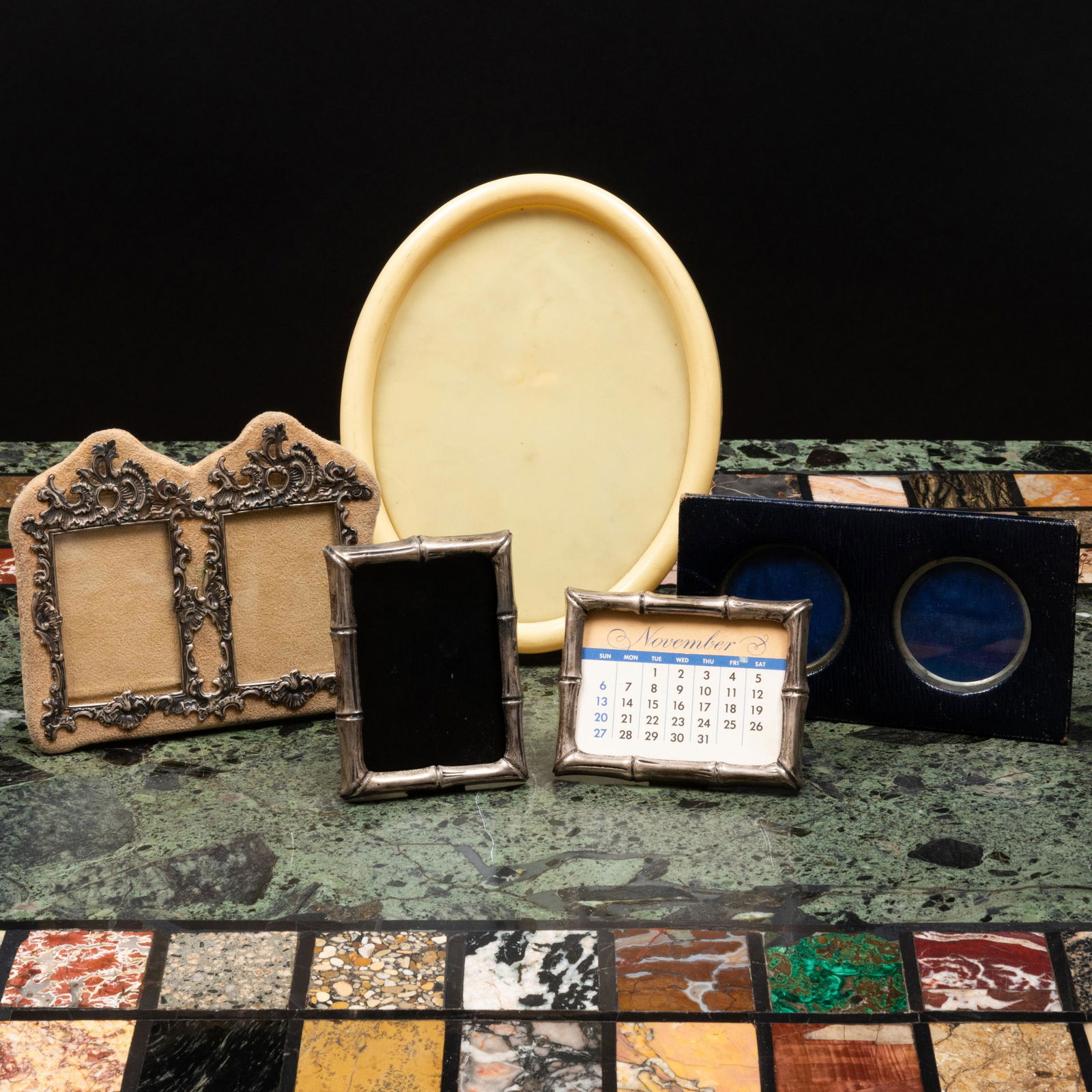 Group of Four Picture Frames and a Calendar: Group of Four Picture Frames and a Calendar Comprising: A Tiffany & Co. silver faux bamboo calendar and frame, marked 'Sterling' An American silver-mounted double frame, marked 'Sterling' A leather do