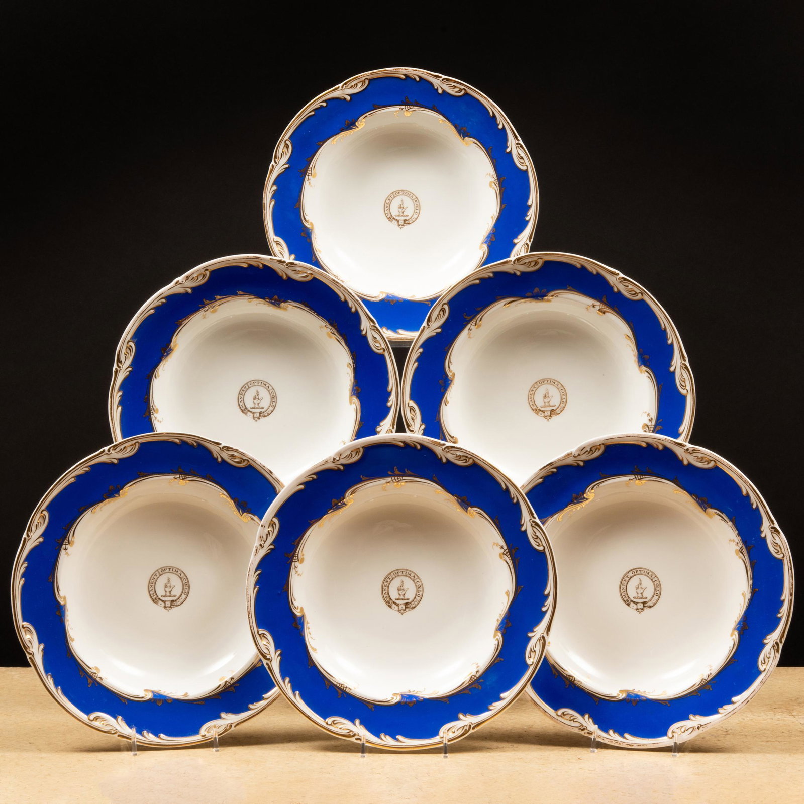 Set of Eight English Blue Ground Porcelain Crested Soup Plates: Set of Eight English Blue Ground Porcelain Crested Soup Plates Impressed registration mark; the banded motto 'Manent Optima Coelo' surrounding a crest. 10 in. diam.