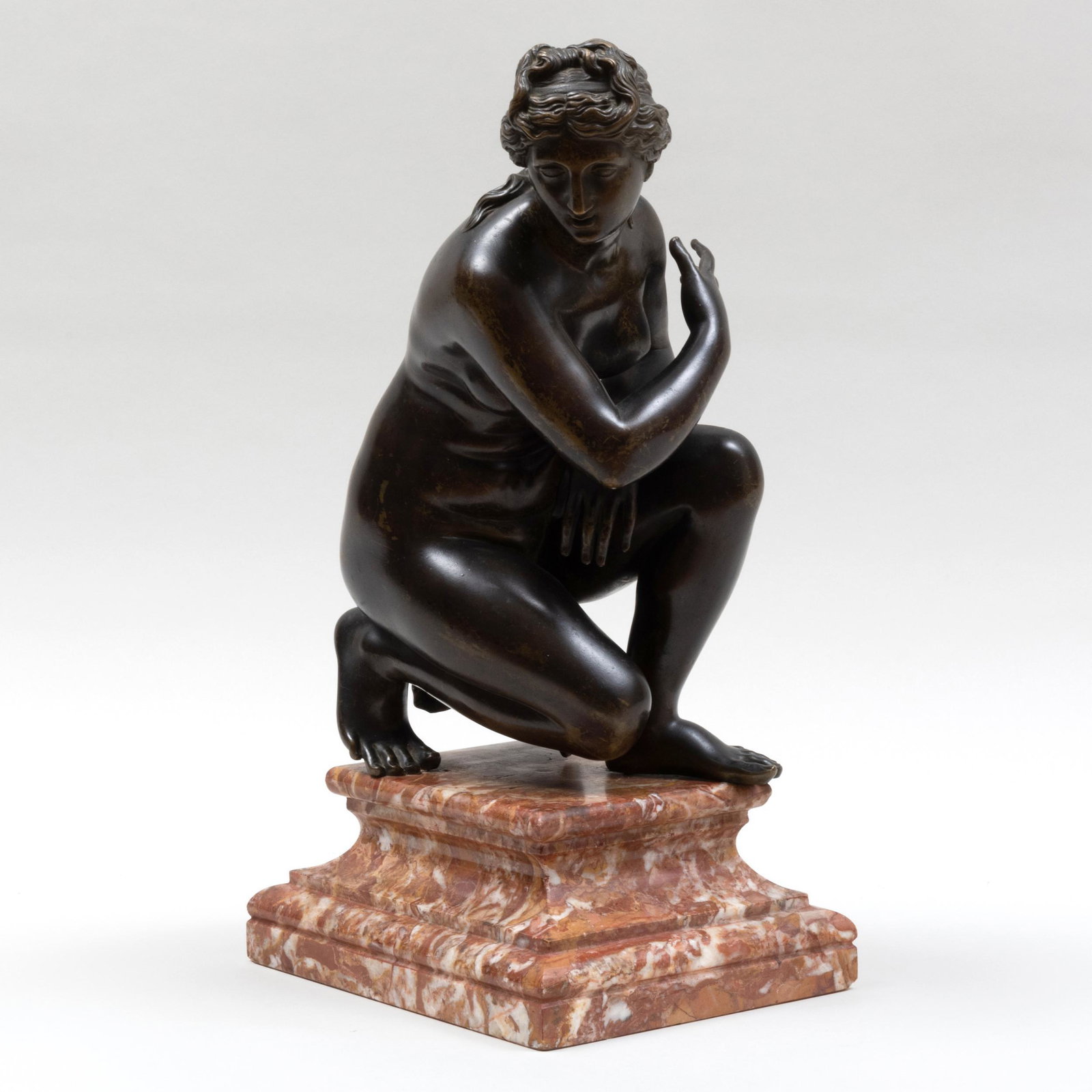 Italian Bronze Model of the Crouching Venus: Italian Bronze Model of the Crouching Venus Raised on a carved marble plinth base. 18 x 7 5/8 x 9 1/2 in. Galerie Chenel, Paris. Property of a European Collector