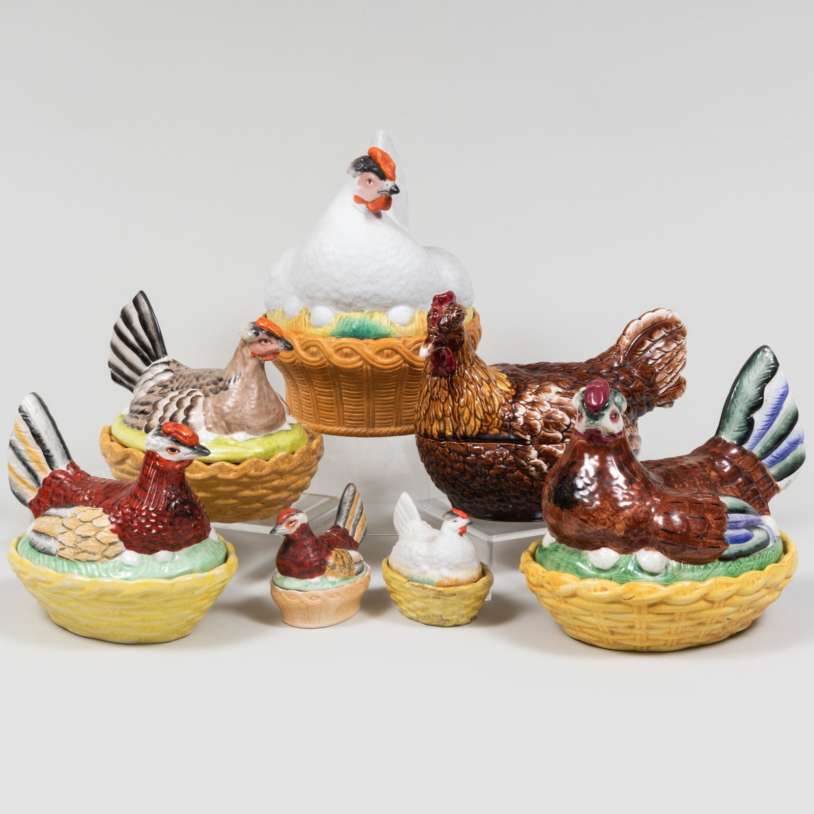 Group of Seven Hen Form Porcelain Boxes and Covers: Group of Seven Hen Form Porcelain Boxes and Covers Unmarked, one larger chicken fitted with interior egg cups and support. The largest 9 1/2 x 10 1/2 x 7 in.