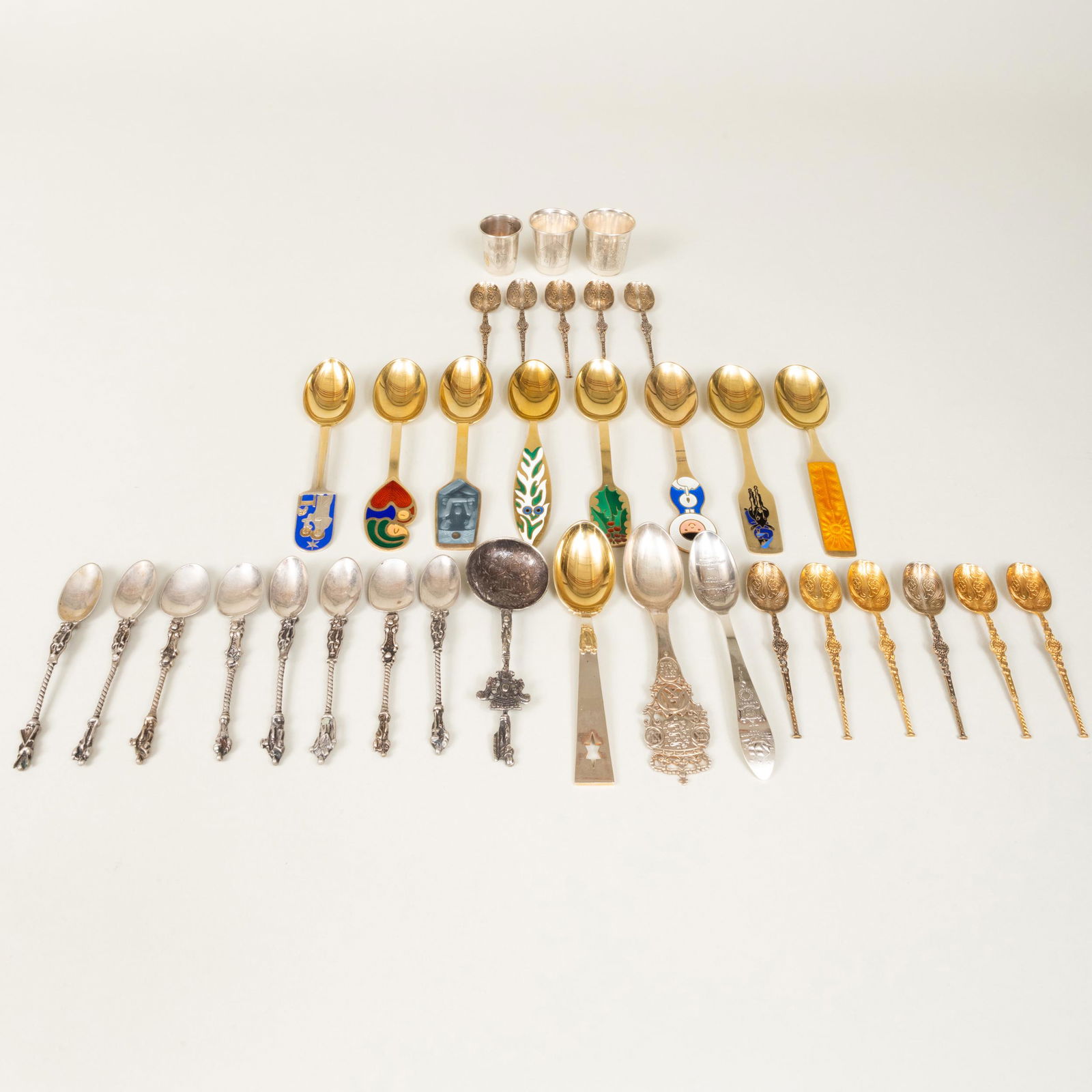 Set of Nine Enameled Silver-Gilt Anton Michelsen Commemorative Holiday Spoons and a Group of Spoons: Set of Nine Enameled Silver-Gilt Anton Michelsen Commemorative Holiday Spoons and a Group of Spoons The holiday spoons marked 'Sterling'. The spoons comprising:A Danish monarchy 1912 spoon, marked 'St