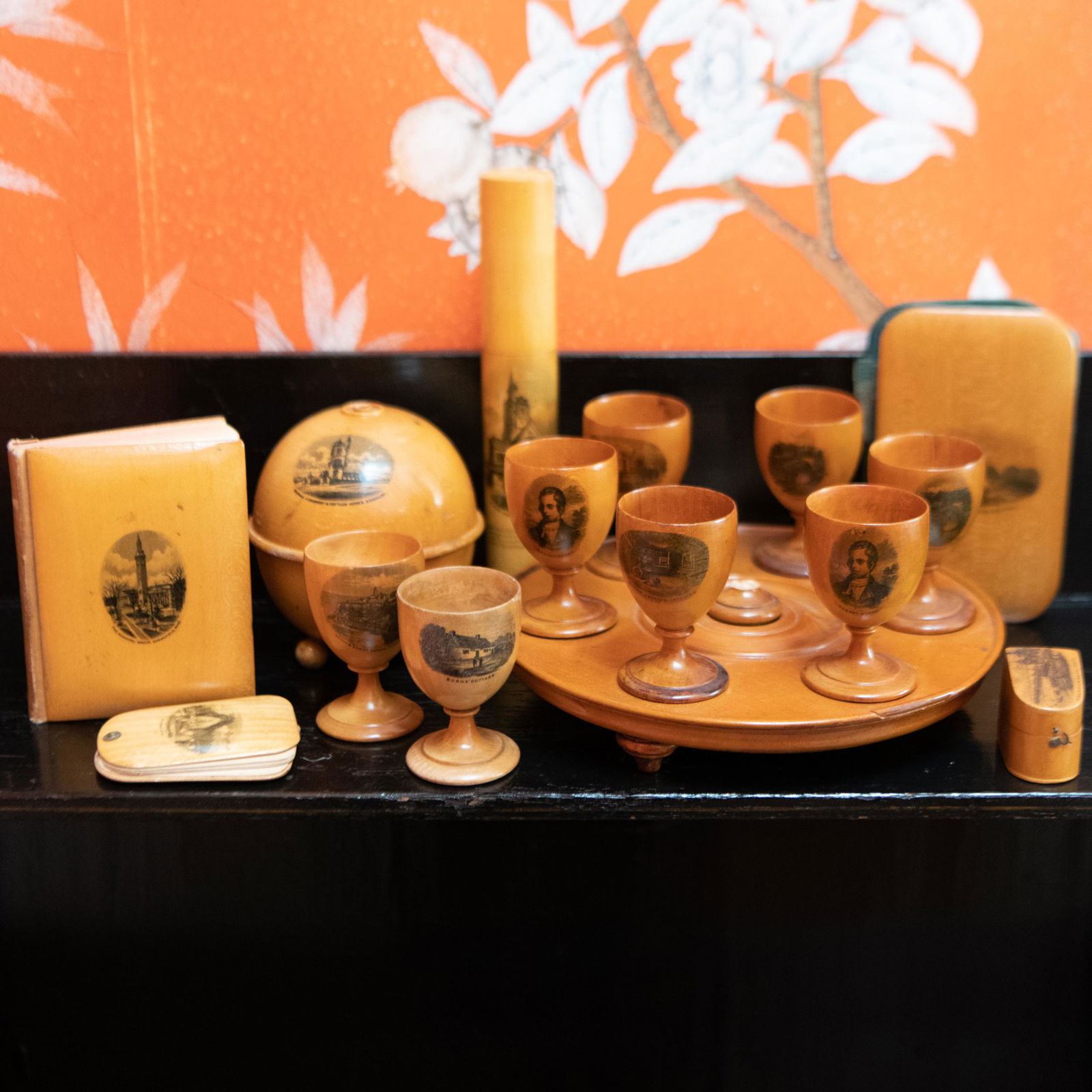 Group of British Souvenir Treen: Group of British Souvenir Treen Comprising: A book of poetry A pencil case Two egg cups Six egg cups on stand A ring box A wallet A string holder The largest 7 3/4 x 1 1/4 in. diam., (14 pcs).<