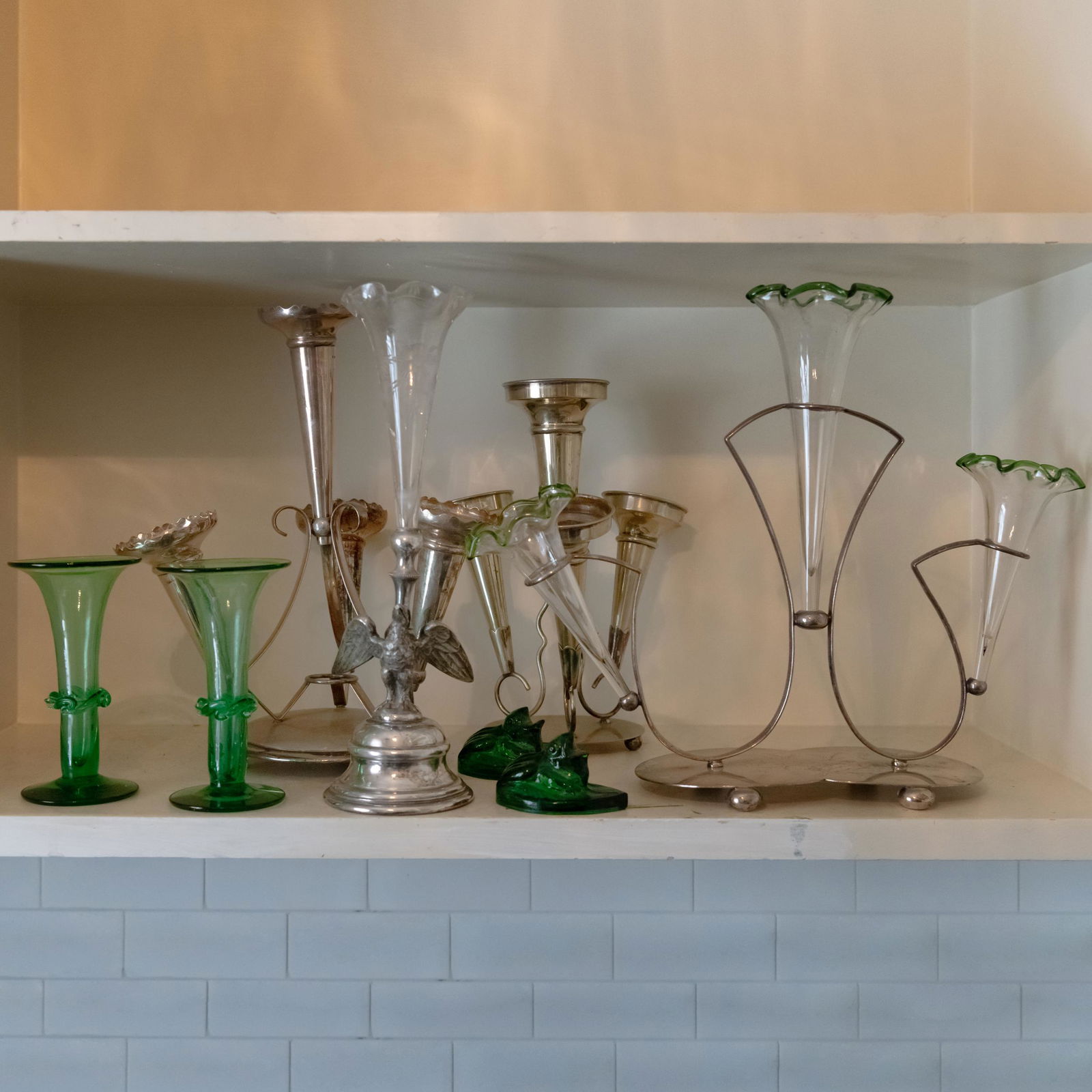 Group of Four Silver Plate Epergnes and Glass Articles: Group of Four Silver Plate Epergnes and Glass Articles Comprising: A cut glass epergne with a bird form support An epergne with three glass trumpets An epergne with four trumpets An epergne with four