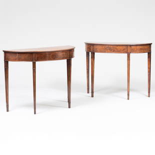 Two George III Inlaid Mahogany Demilune Console Tables: Two George III Inlaid Mahogany Demilune Console Tables Each with a metal label: 'ANTIQUE FURNITURE from NORMAN ADAMS 8-10 HANS ROAD, LONDON. SW3' 30 1/2 x 40 x 16 1/4 in. 30 3/4 x 39 3/4 x 16 1/4 in.