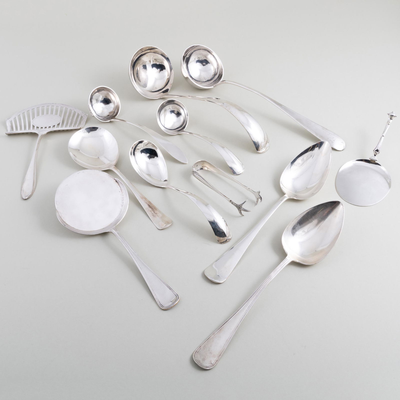 Group of Dutch Silver Serving Utensils: Group of Dutch Silver Serving Utensils Each marked '.833'. Comprising: A soup ladle Two sauce ladles A casserole spoon A pastry server An asparagus server A potato spoon Two serving spoons <