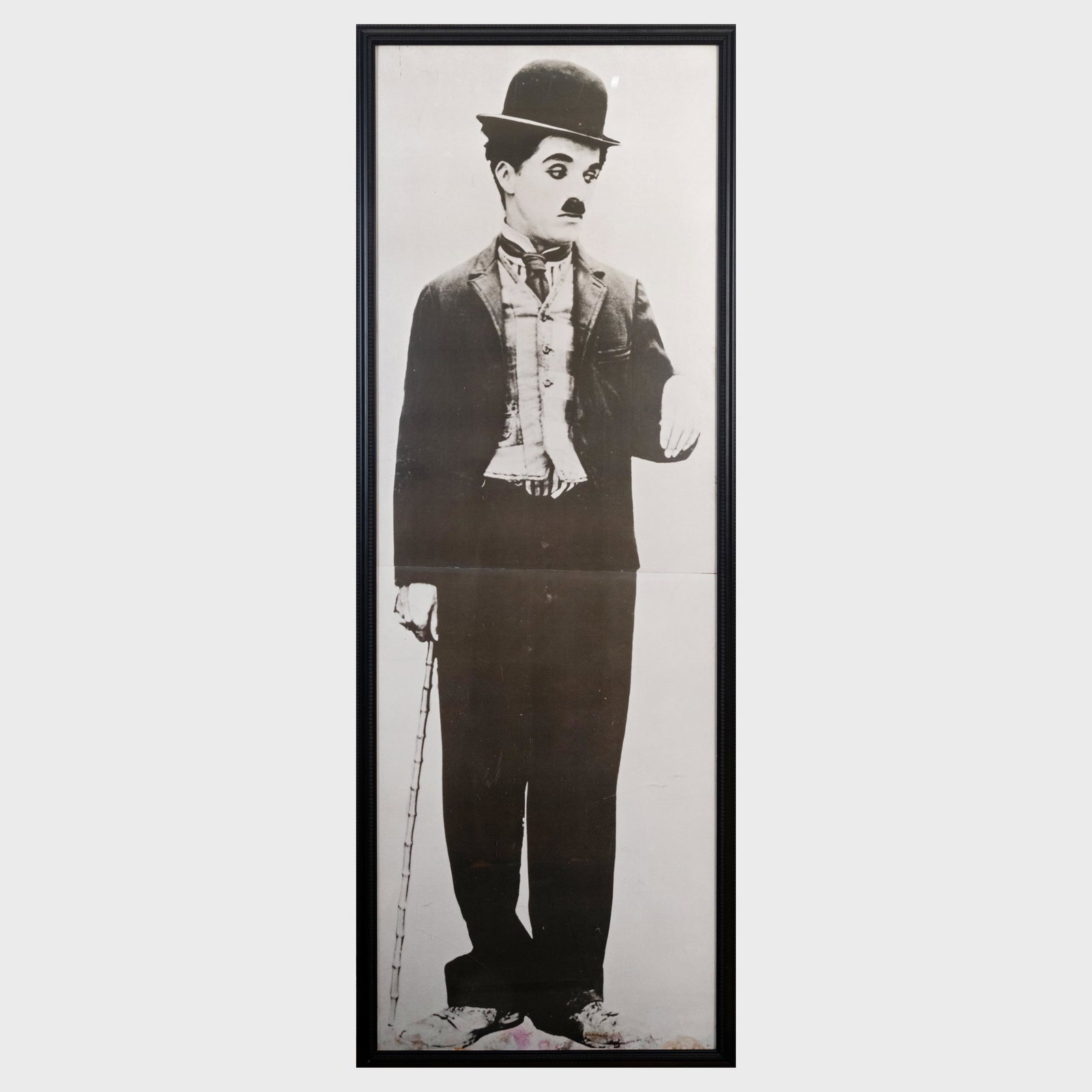 Charlie Chaplin: Charlie Chaplin Photomechanical reproduction on two sheets of paper. 77 x 28 in. (frame). Note: This image hung in the Newman's barn in Westport, CT next to the piano that was the center of many gathe
