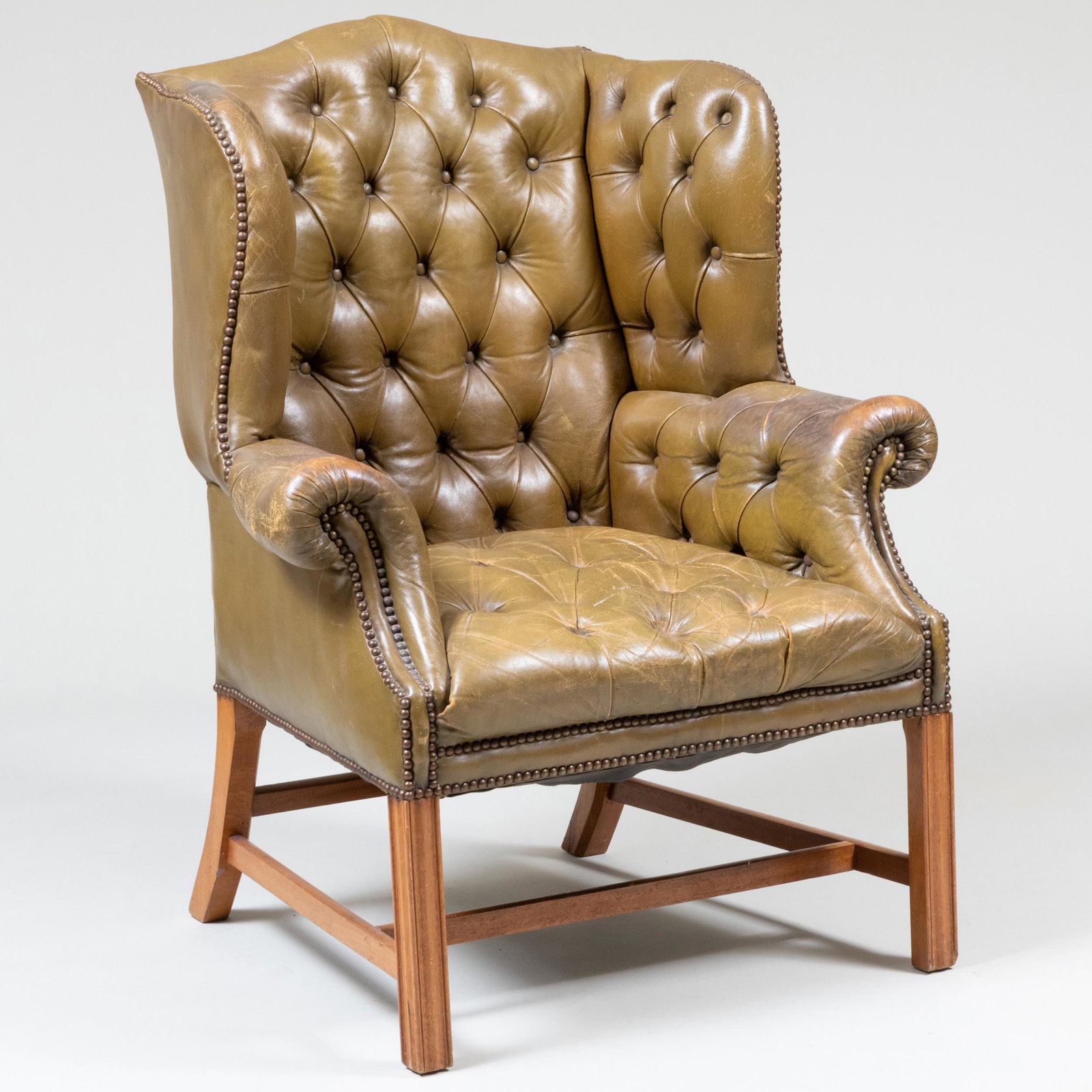 George III Style Mahogany and Tufted Leather Wing Chair: George III Style Mahogany and Tufted Leather Wing Chair 43 1/2 x 34 x 31 1/2 in., seat height 17 1/2 in.