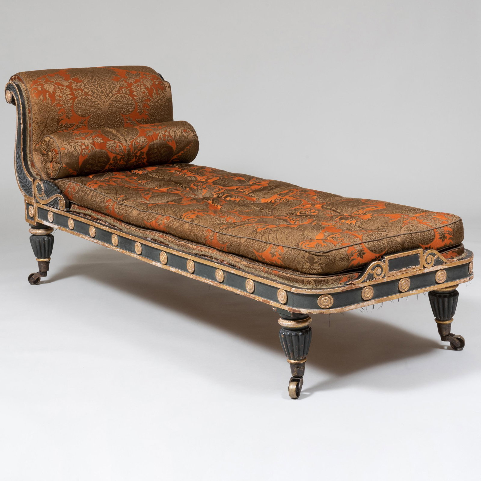 English Regency Carved, Ebonized and Parcel-Gilt Upholstered Chaise Lounge: English Regency Carved, Ebonized and Parcel-Gilt Upholstered Chaise Lounge Together with a matching squab cushion. 32 1/2 in. x 6 ft. 7 in. x 27 in., seat height 17 1/2 in.