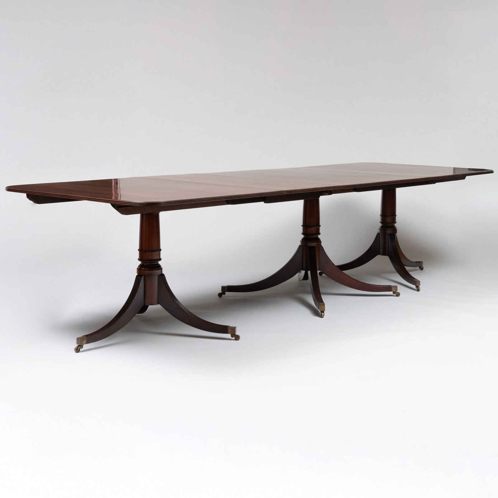 Regency Style Mahogany Three Pedestal Dining Table: Regency Style Mahogany Three Pedestal Dining Table With two leaves. 30 in. x 44 in. x 9 ft. (closed), 30 in. x 44 in. x 12 ft. (fully extended), each leaf 18 in.