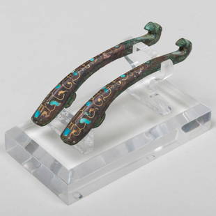 Pair of Chinese Inlaid Bronze Belt Hooks: Pair of Chinese Inlaid Bronze Belt HooksTogether with a lucite stand.The hooks 3 1/2 in. long, 2 1/4 x 4 x 3 1/8 in. (overall).