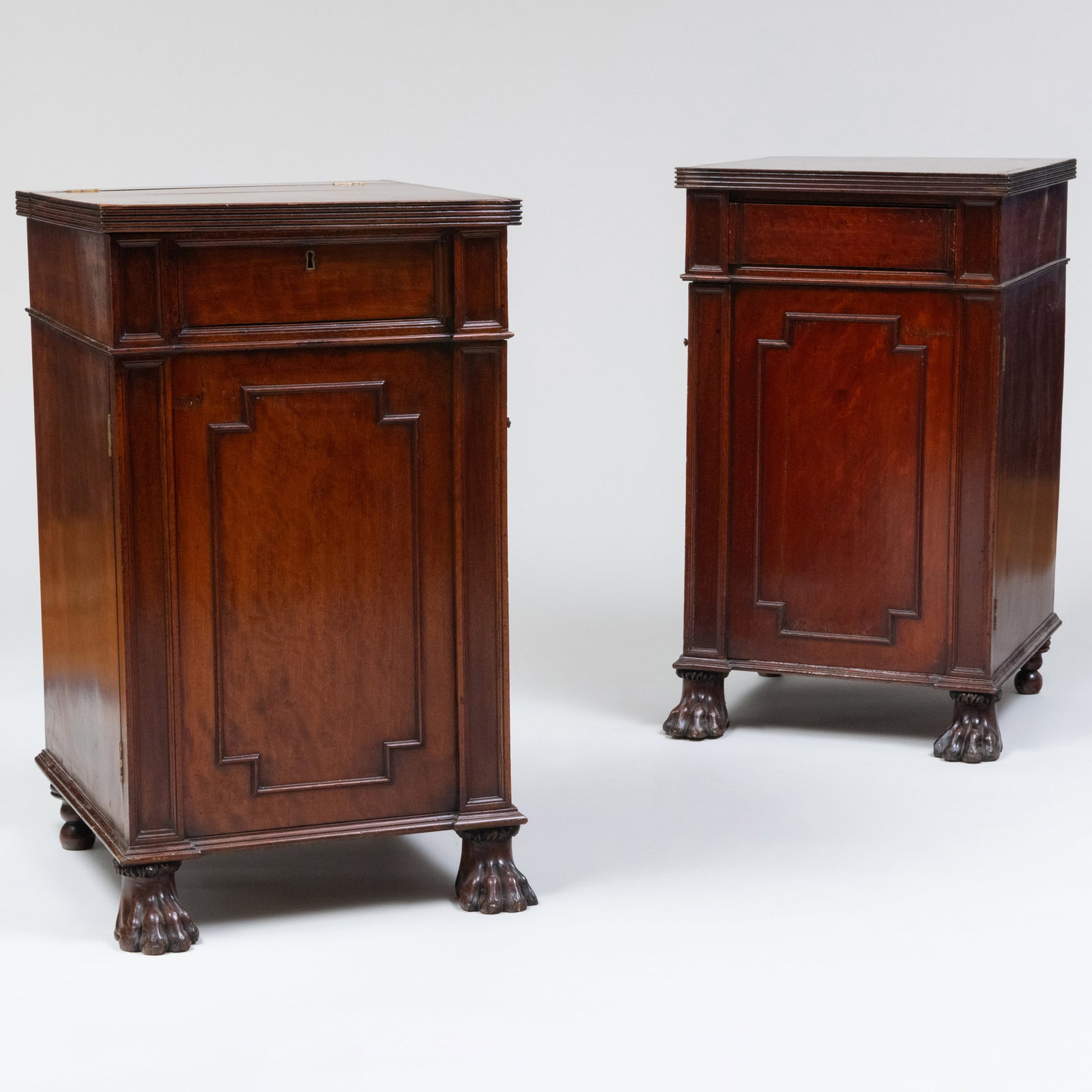 Pair of George III Mahogany Pedestal Cabinets: Pair of George III Mahogany Pedestal Cabinets Both tops open, one pedestal opens to bottle drawer, the other pedestal opens to shelves. 36 in x 21 1/4 in. x 24 1/2 in.
