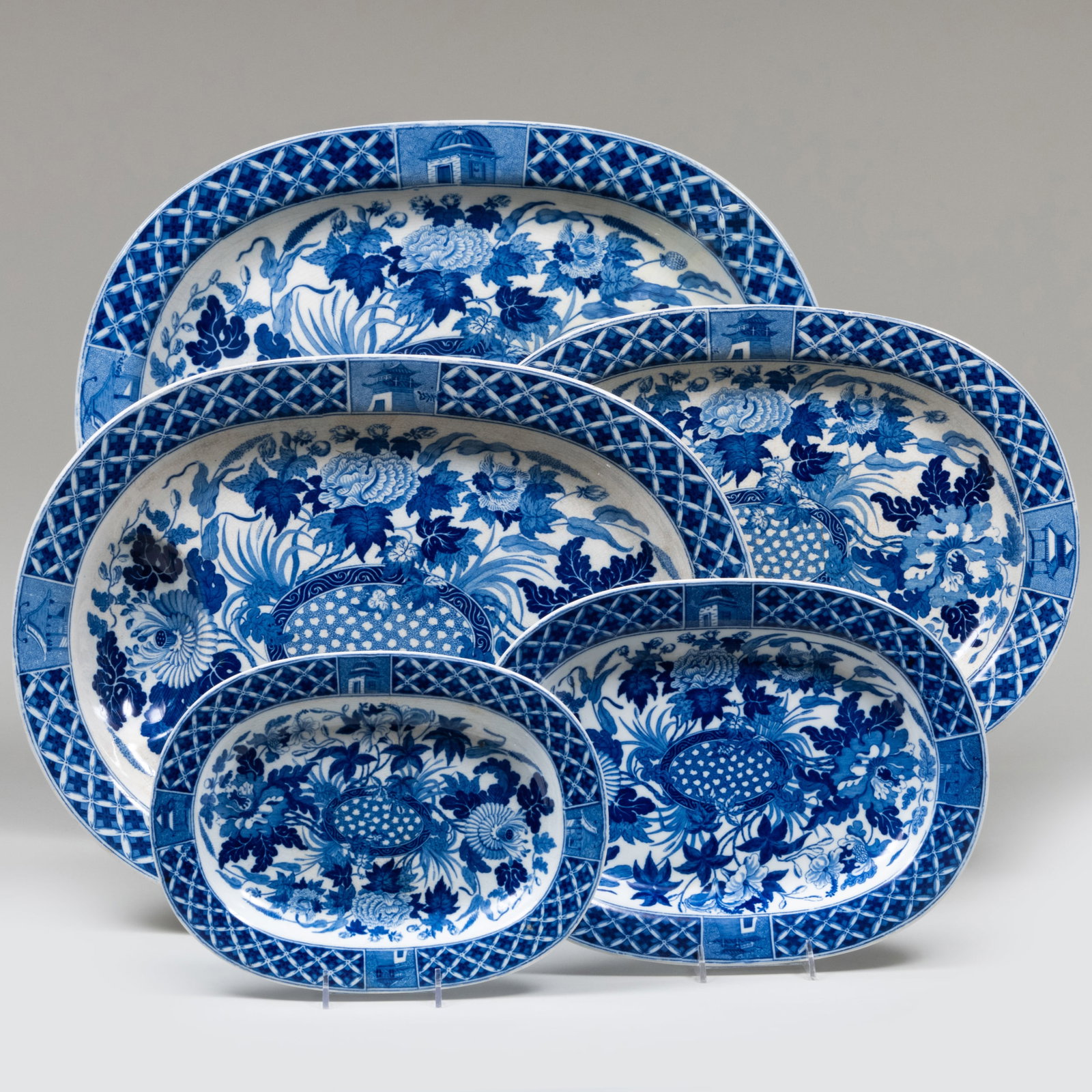Group of Wedgwood Porcelain Platters in the 'Hibiscus' Pattern: Group of Wedgwood Porcelain Platters in the 'Hibiscus' Pattern Impressed mark. Comprising: A large meat platter A set of four oval platters in graduated sizes A well-and-tree platter The largest 20 1/