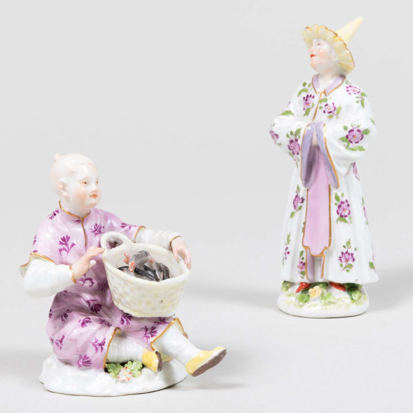 Meissen Porcelain Chinoiserie Figure of a Fisherboy and a Standing Figure of a Child: Meissen Porcelain Chinoiserie Figure of a Fisherboy and a Standing Figure of a Child Each with blue crossed sword mark. The standing figure 5 in. high, the seated figure 3 1/2 in. high. Note: The stan