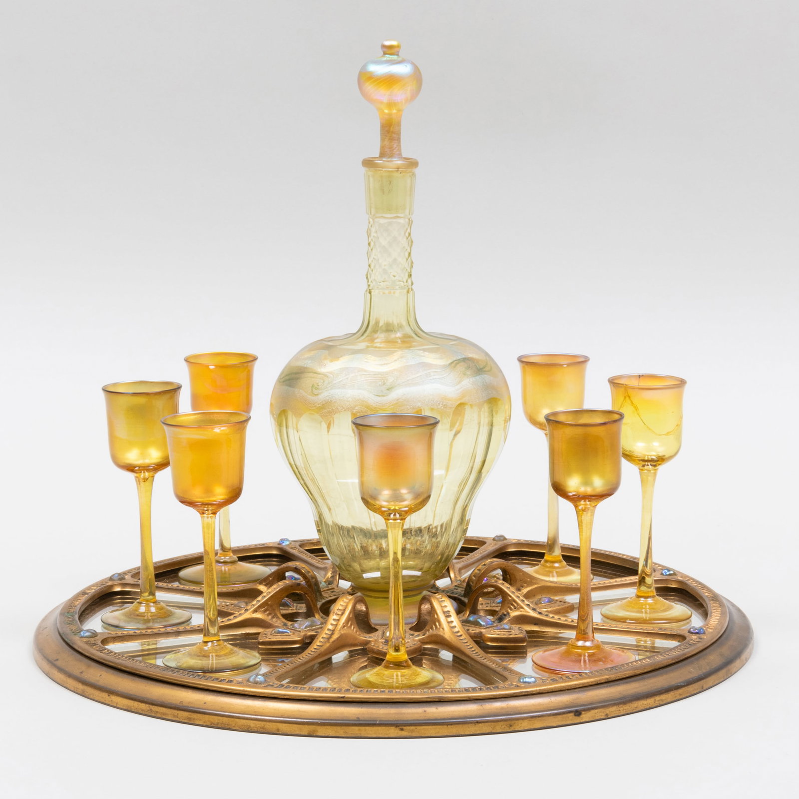 Tiffany Studios Favrile Glass Decanter Set and Tray: Tiffany Studios Favrile Glass Decanter Set and Tray The glass signed in etch, the tray stamped no. 1735. The set comprising: A decanter and stopper Eight cordials The decanter 11 in. high, the tray 13