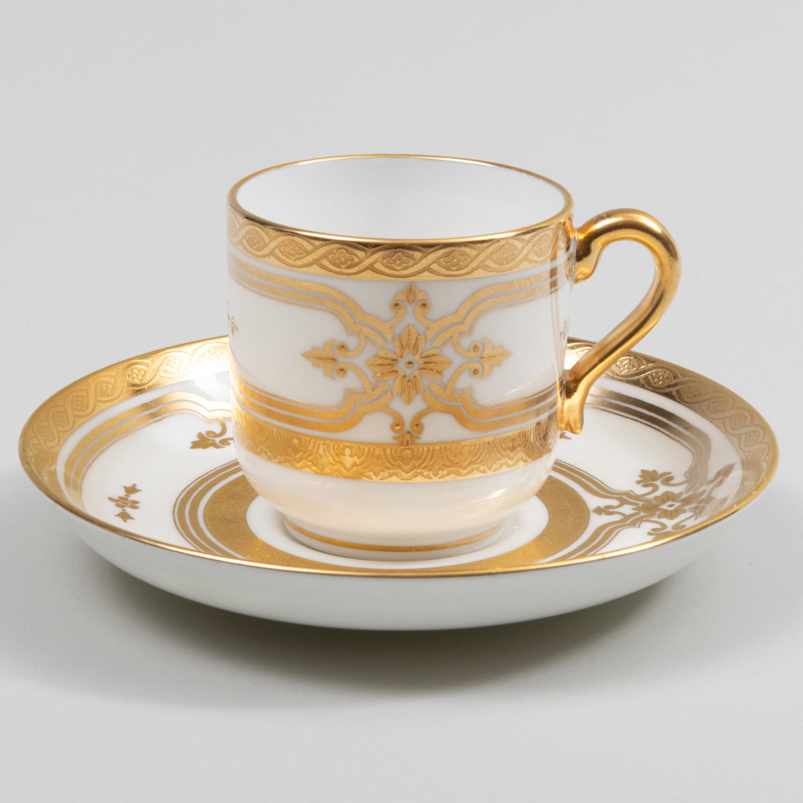 Set of Fourteen Mintons Gilt Decorated Porcelain Demitasse Cups and Saucers: Set of Fourteen Mintons Gilt Decorated Porcelain Demitasse Cups and Saucers Puce printed mark. 2 1/4 x 2 1/4 in. diam. The Collection of Jordan Saunders.