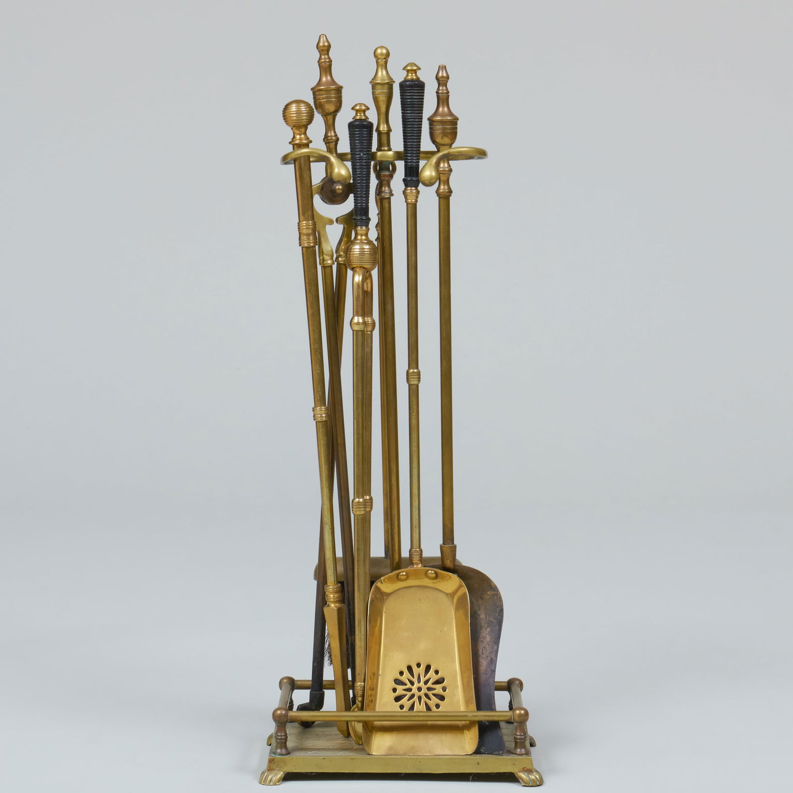 Miscellaneous Fireplace Equipment: Miscellaneous Fireplace Equipment Comprising: Two shovels Two tongs One poker One broom Together with a stand. Longest 26 1/2 in.