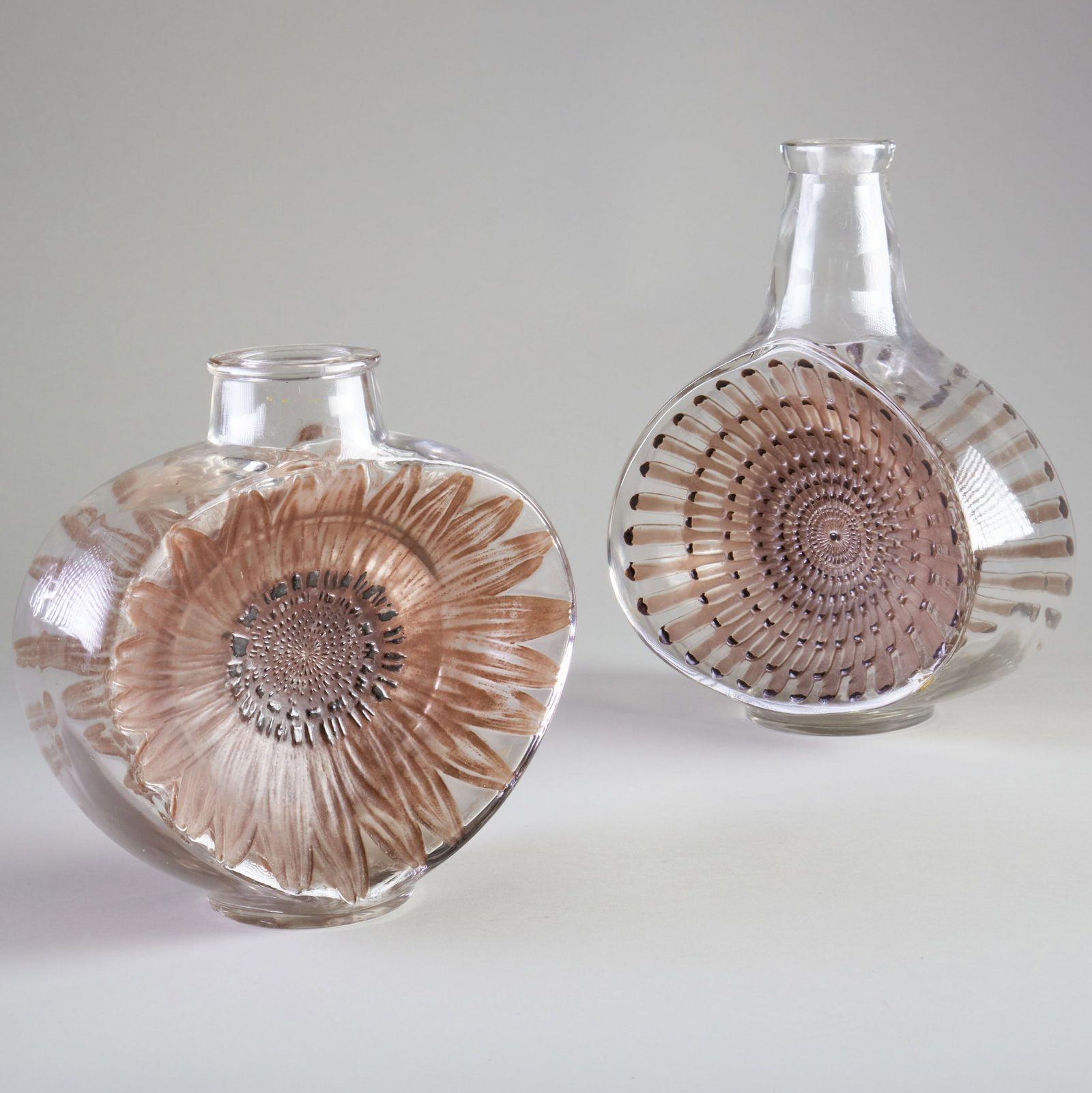 Lalique Patinated Glass 'Reine Marguerite' Decanter and a 'Soleil' Vase: Lalique Patinated Glass 'Reine Marguerite' Decanter and a 'Soleil' Vase The marguerite signed in etch 'Lalique', Marcilhac no. 3155, model introduced 1913; the soleil signed in etch 'R. Lalique', Marc