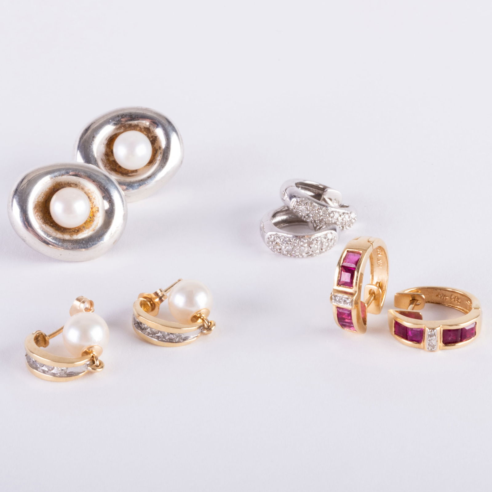 Group of Four Pairs of Earrings: Group of Four Pairs of Earrings Including a pair of silver and pearl earrings by Robert Lee Morris, a gold, diamond and pearl pair of earrings, a white gold and diamond pair of earrings and a gold, ru