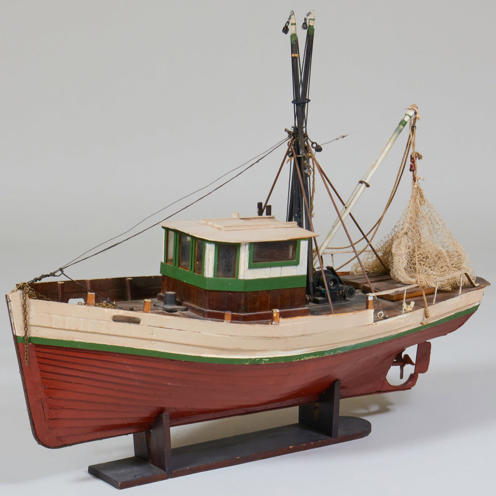 Model of a Trawler: Model of a Trawler Painted wood and metal, raised on stand. The boat 28 x 40 x 15 in., 33 x 40 x 15 in. (overall).