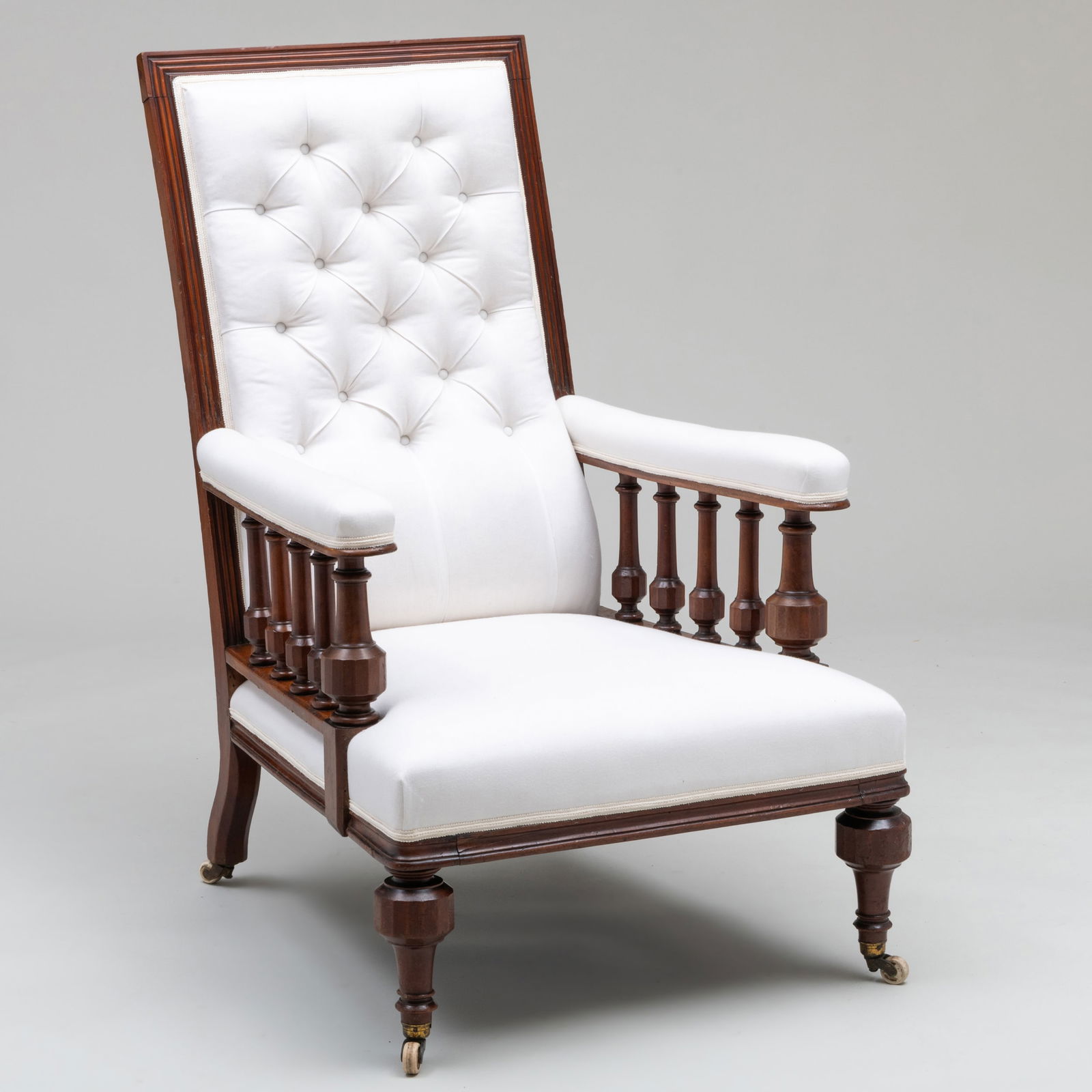 Victorian Carved Mahogany and Tufted Linen Armchair: Victorian Carved Mahogany and Tufted Linen Armchair Raised on casters. 46 3/4 x 28 3/4 x 35 in., seat height 15 3/4 in.