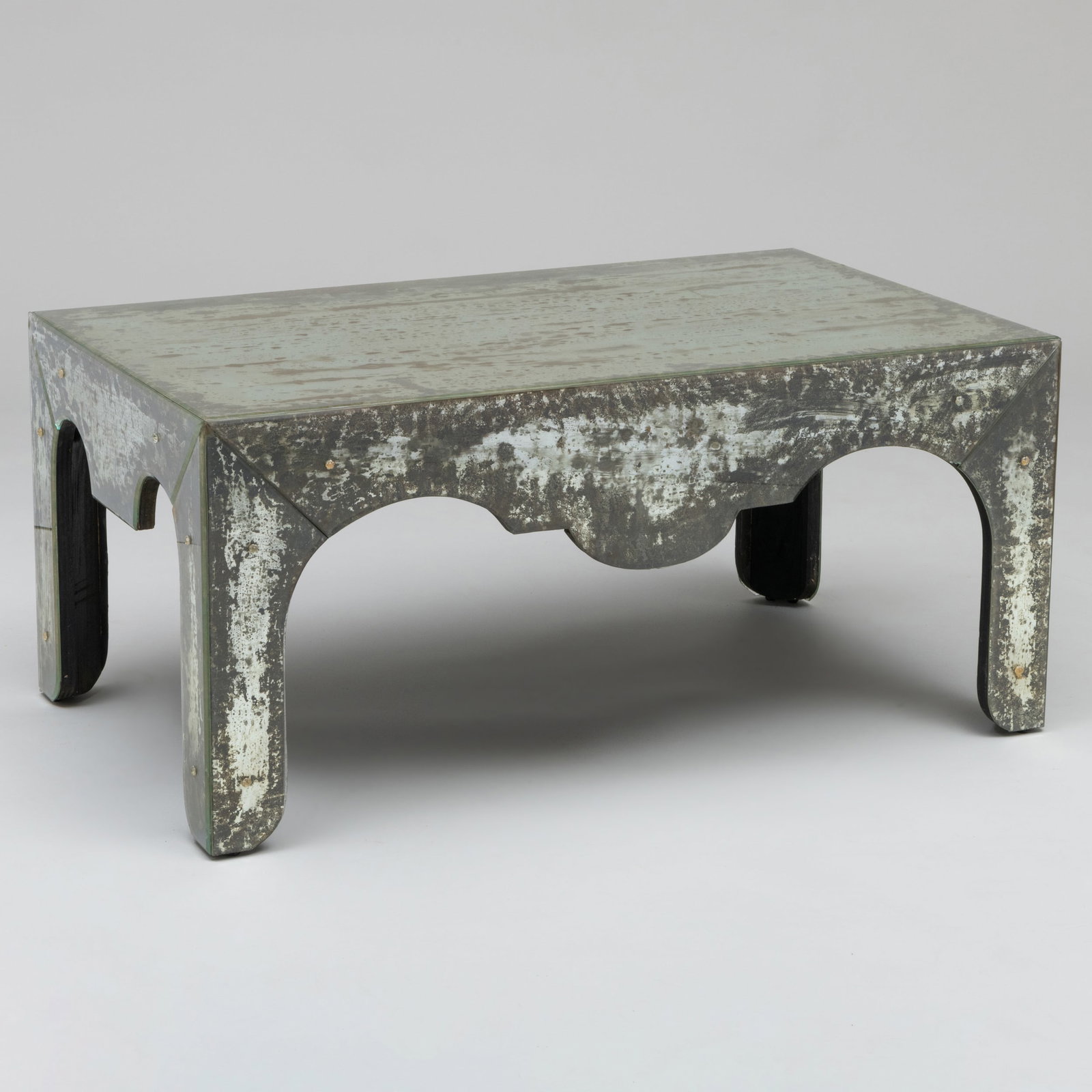 Distressed Mirrored-Glass Coffee Table: Distressed Mirrored-Glass Coffee Table 18 1/2 x 40 1/4 x 24 1/2 in. The Collection of Jordan Saunders.