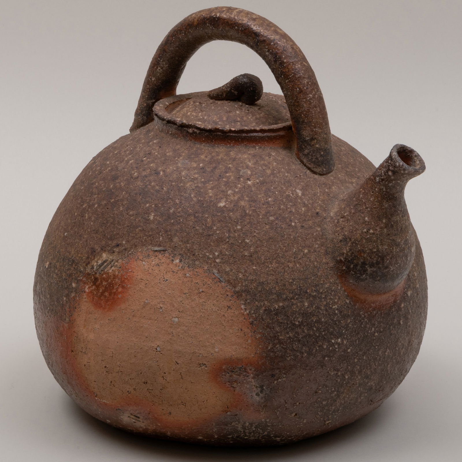 Japanese Shigaragi Wood Fired Earthenware Teapot and Cover: Japanese Shigaragi Wood Fired Earthenware Teapot and Cover 11 x 11 x 10 in. Mashiko Folkcraft, San Fransisco, CA, 1995. The Collection of Gordon and Zanne Stewart.