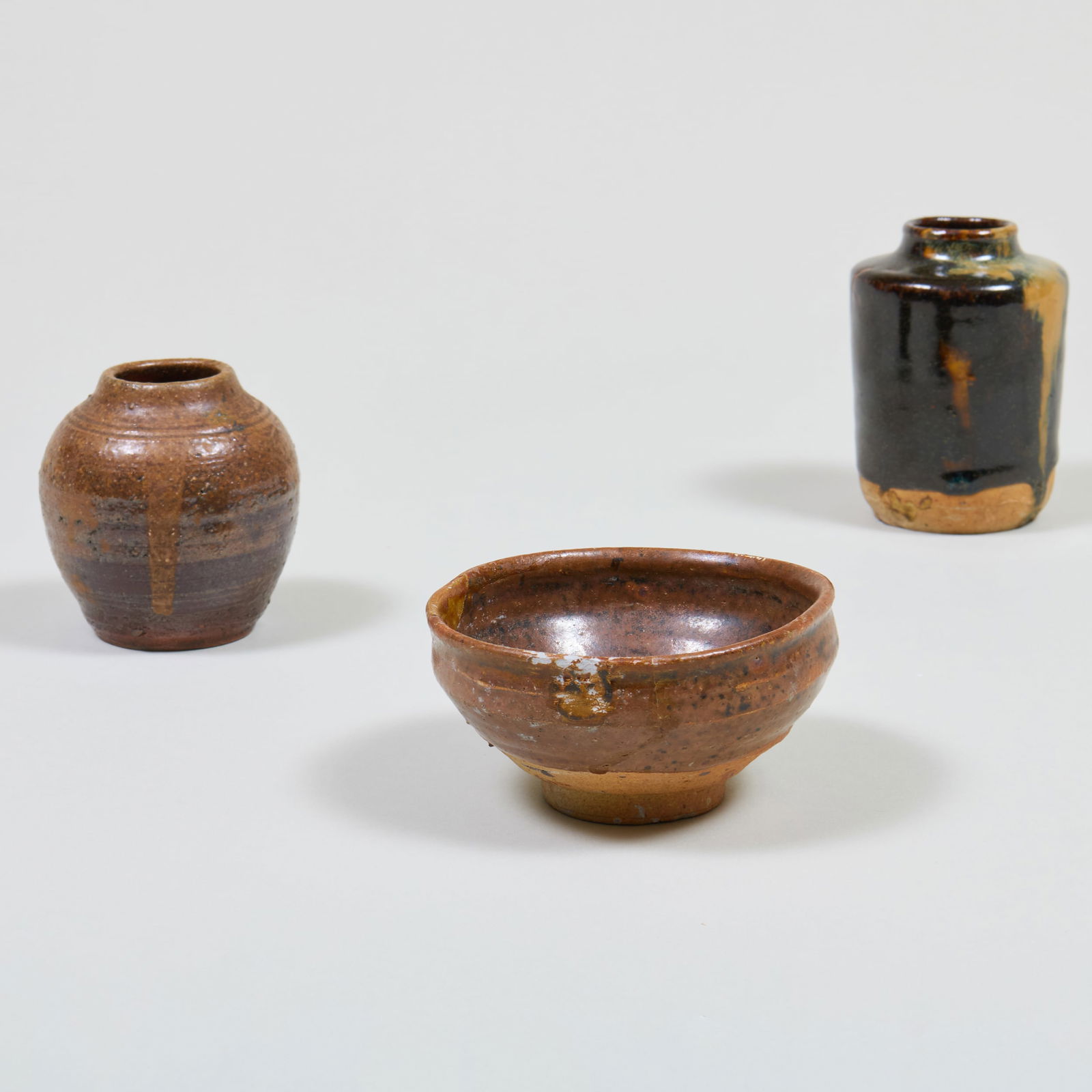 Group of Three Japanese Miniature Wares: Group of Three Japanese Miniature Wares Unmarked. Comprising: A tea bowl A jarlet with dimple A tea caddy The largest 3 3/8 x 2 1/2 in. diam. The tea bowl Kottoya - McMullen's Japanese Antiques, LA,