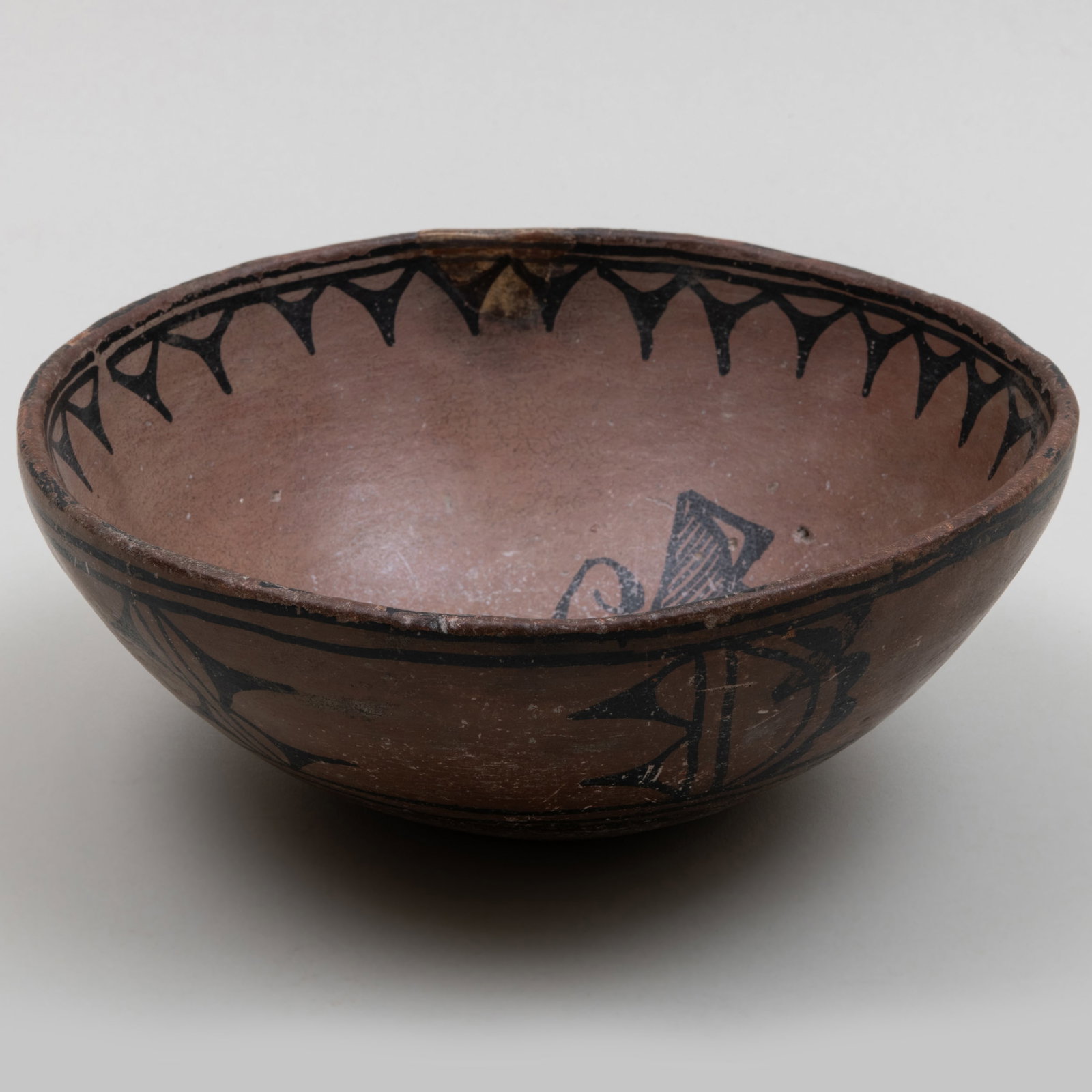 Small Cochiti Brown and Black Pottery Bowl with Butterfly Motif: Small Cochiti Brown and Black Pottery Bowl with Butterfly Motif 3 x 8 1/4 in. diam. The Collection of Gordon and Zanne Stewart.