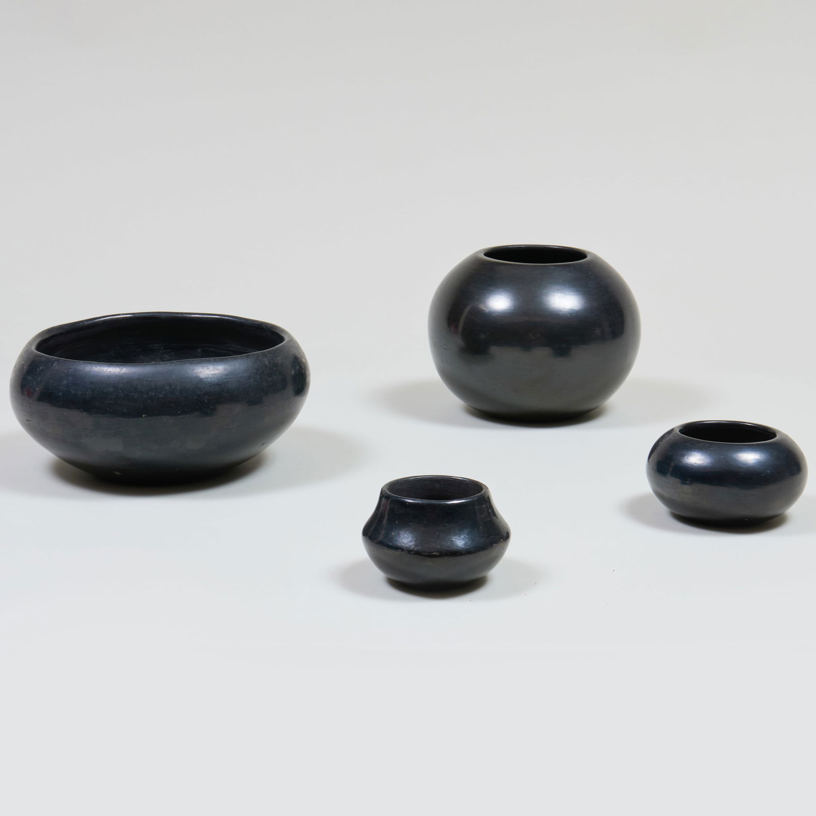 Group of Four Burnished Black Pots: Group of Four Burnished Black Pots Comprising: A Maria Martinez Poveka San Ildefonso small bowl, incised signature A Lupete Martinez San Ildefonso globular bowl, incised signature A San Ildefonso smal