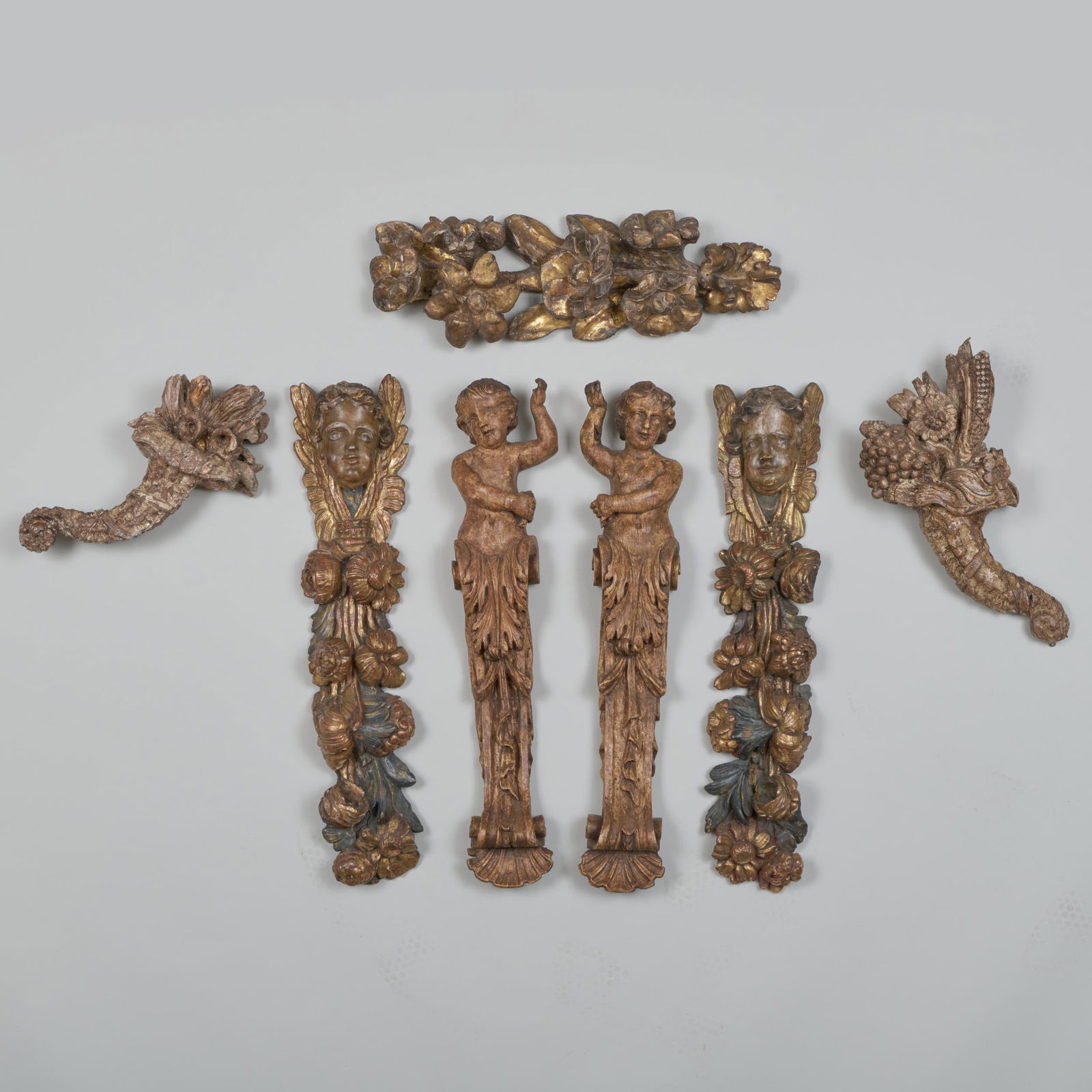 Group of Seven continental Carved and Painted Wall Ornaments: Group of Seven continental Carved and Painted Wall Ornaments 29 x 6 1/4 in., the largest, a pair of figural terms.
