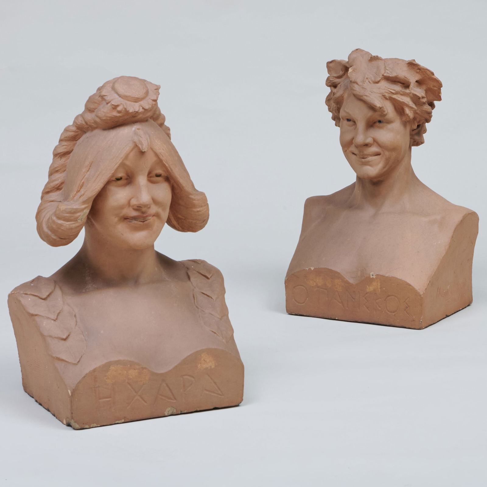 Jonathan Scott Hartley (1845-1912): Pair of Busts: Jonathan Scott Hartley (1845-1912): Pair of Busts Slip decorated terra cotta, incised signature, named in Greek on bases. 23 1/2 x 16 x 11 in.
