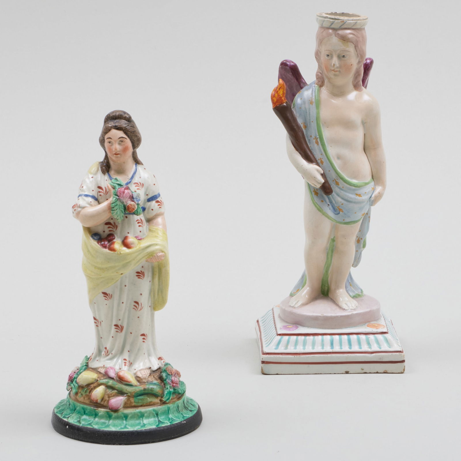 English Staffordshire Figure and a Candlestick: English Staffordshire Figure and a Candlestick Unmarked. The figure 7 1/2 x 3 3/8 in. diam., the candlestick 8 3/4 x 3 1/2 x 3 1/2 in. Sold Sotheby's London Lot 1328 Estate of Giuseppi Rossi, March 12