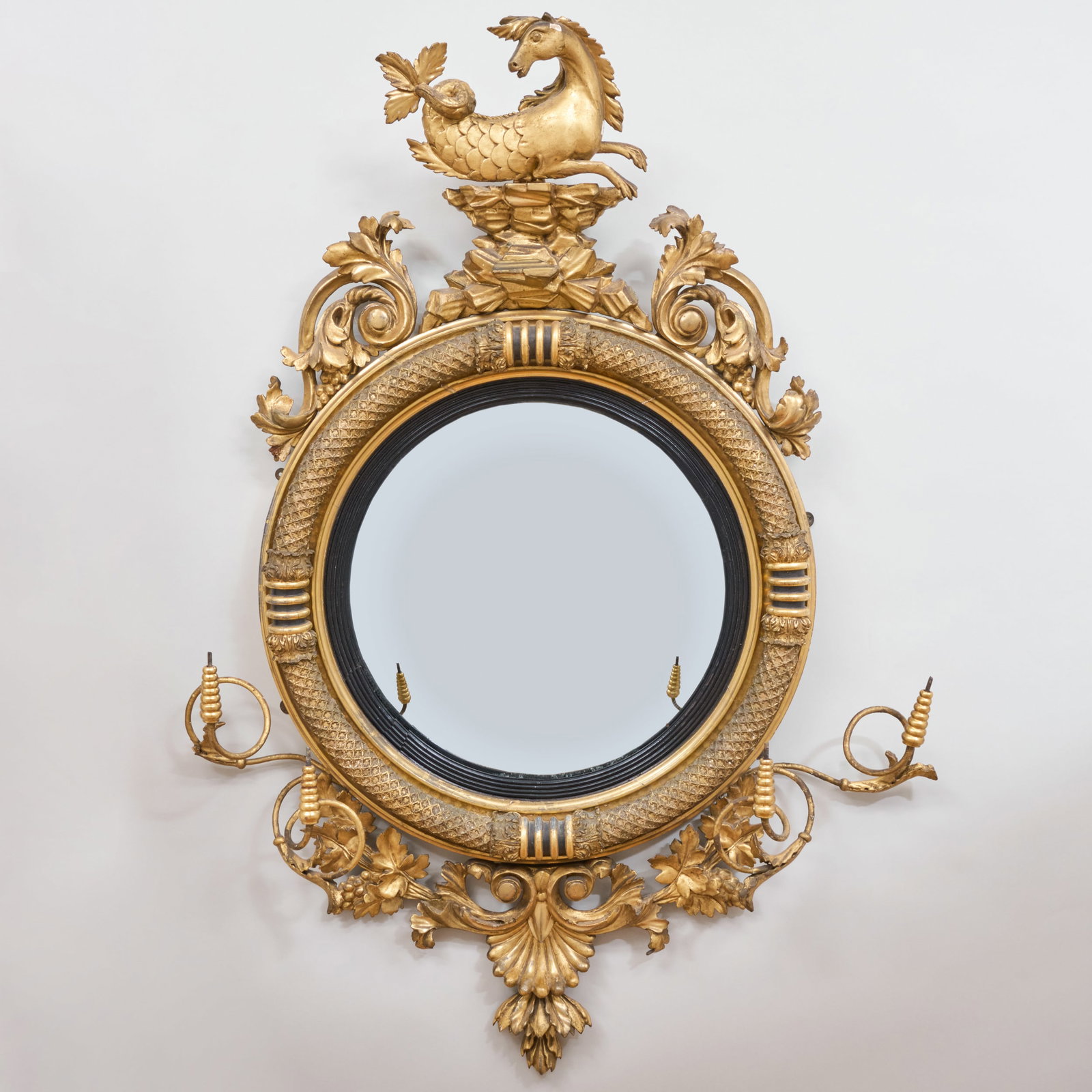 Late Regency Giltwood and Ebonized Convex Girandole Mirror: Late Regency Giltwood and Ebonized Convex Girandole Mirror 47 x 33 1/2 in. The Estate of Carolyn Pesnell Amory, New York.