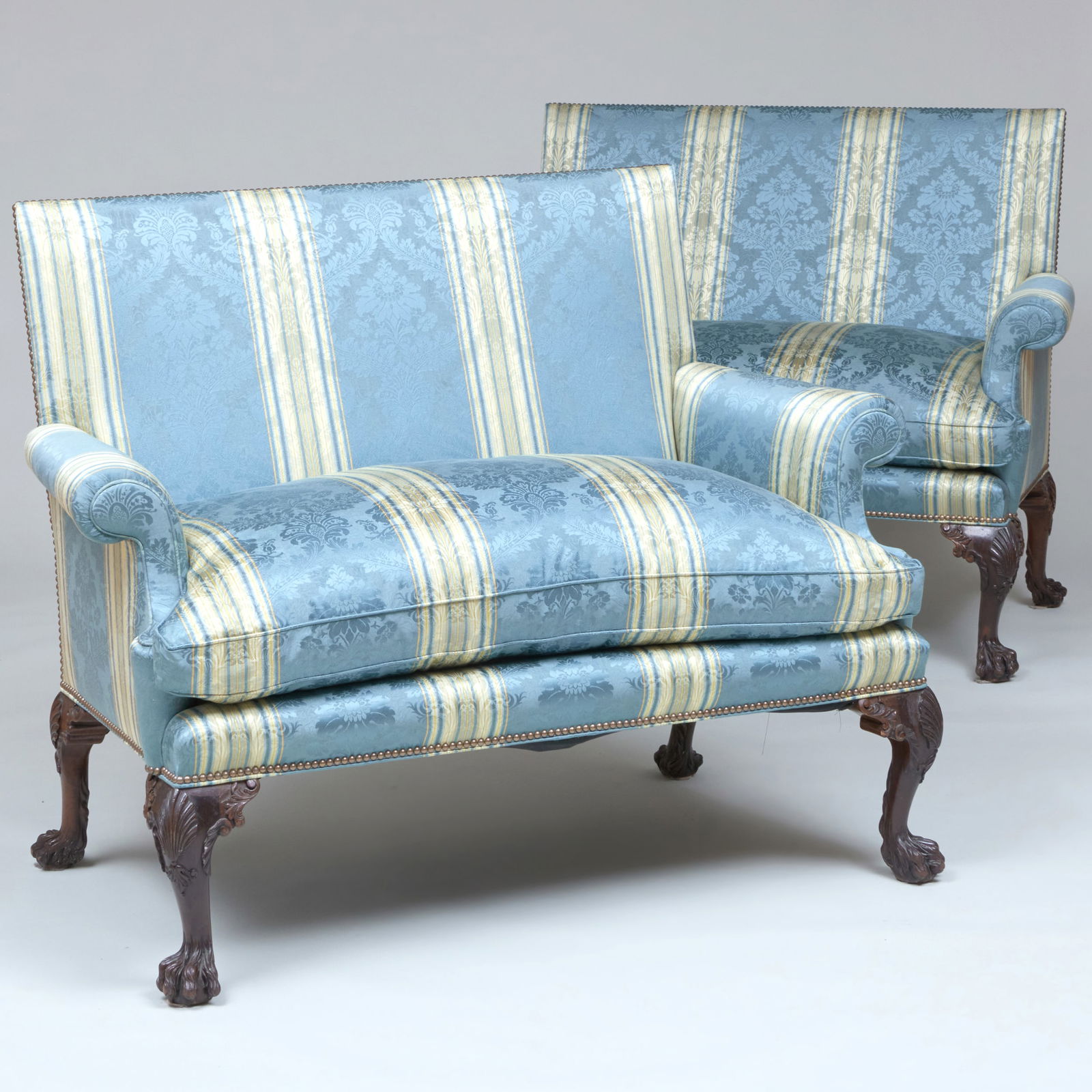 Pair of George II Style Carved Mahogany Settees: Upholstered in silk damask fabric. 41 1/2 x 4 ft. 5 1/2 in. x 31 in., seat height 21 1/2 in. The Estate of the late Grace M. Geddes (Mrs. Donald G. Geddes), Glen Cove, Long Island; sold Parke-Bernet G