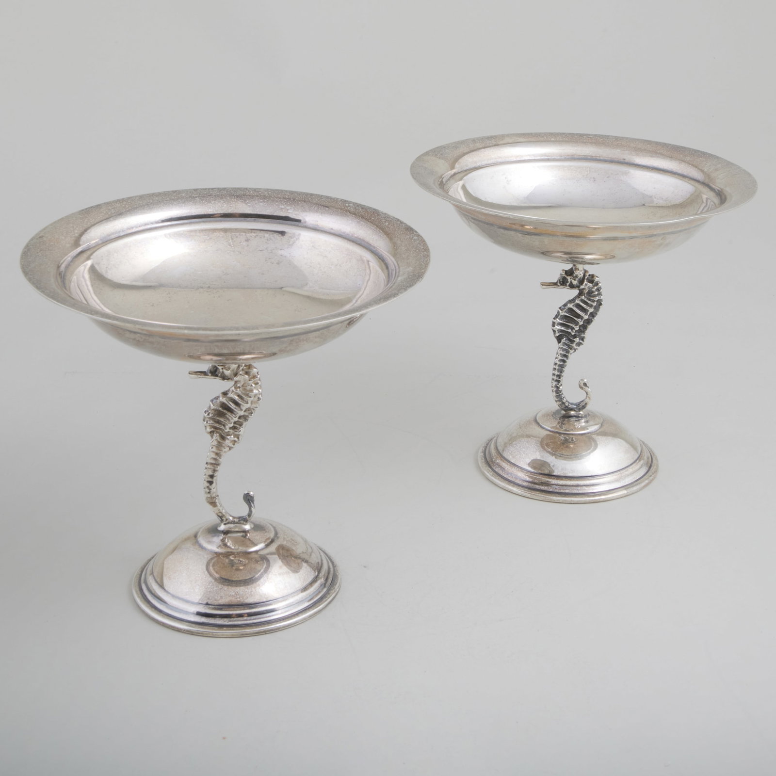Pair of American Silver Seahorse Tazza: Pair of American Silver Seahorse Tazza Each marked 'Sterling'. 5 1/4 x 5 1/2 in. diam., 15 oz. approx. weight. The Mario Buatta-Designed Home of Patricia Altschul, Charleston, SC.