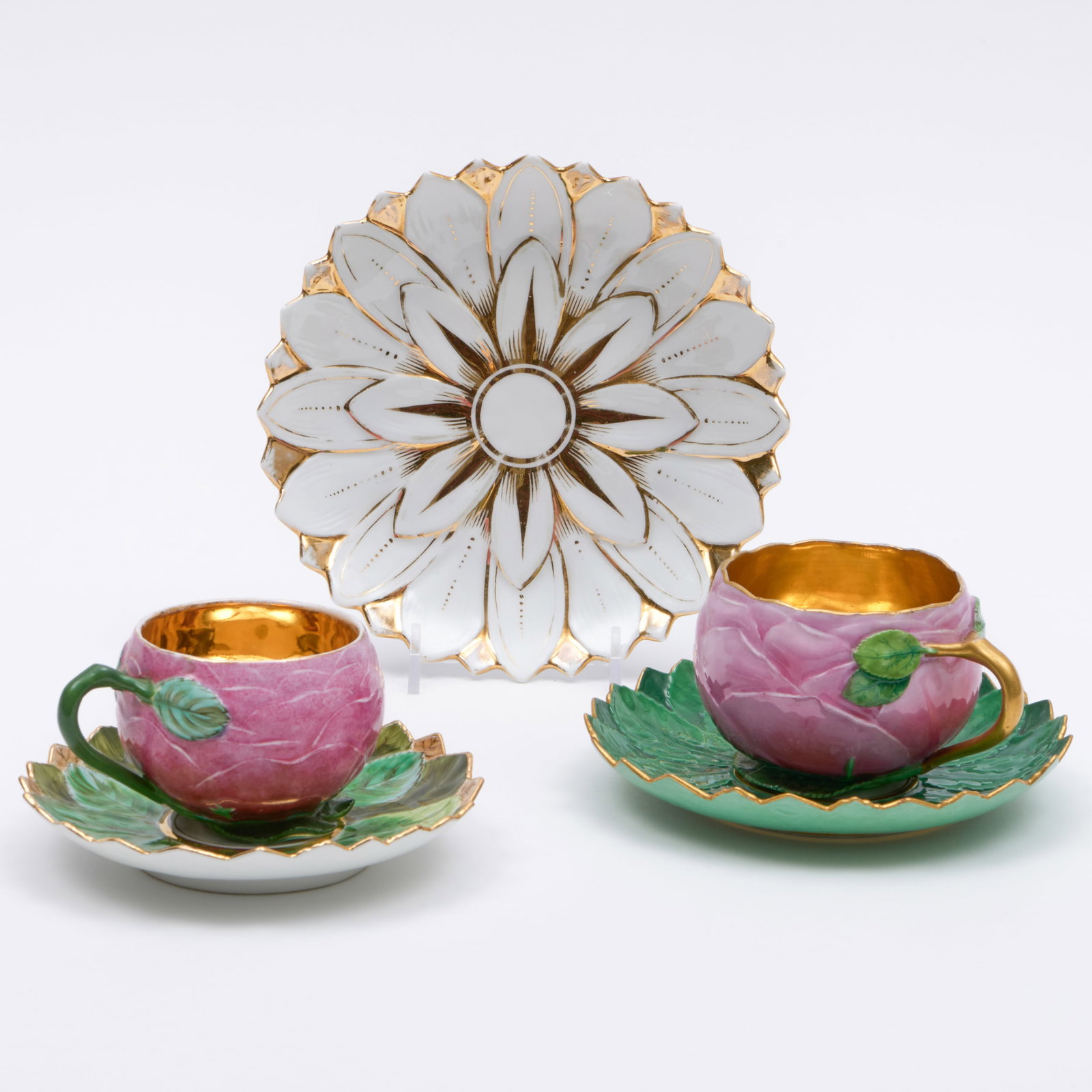 Meissen and Berlin Porcelain Rosebud Teacups and Saucers: Meissen and Berlin Porcelain Rosebud Teacups and Saucers The first with blue crossed sword mark; the second with a blue scepter mark; together with a floriform saucer. The Meissen cup and saucer 3 x 5
