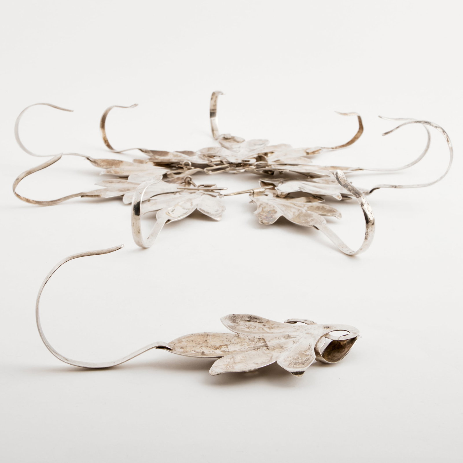 Set of Ten Silver Plate Floriform Hooks: Set of Ten Silver Plate Floriform Hooks 7 1/2 in. long. The Collection of James M. Labaugh Antiques, Pound Ridge, NY.