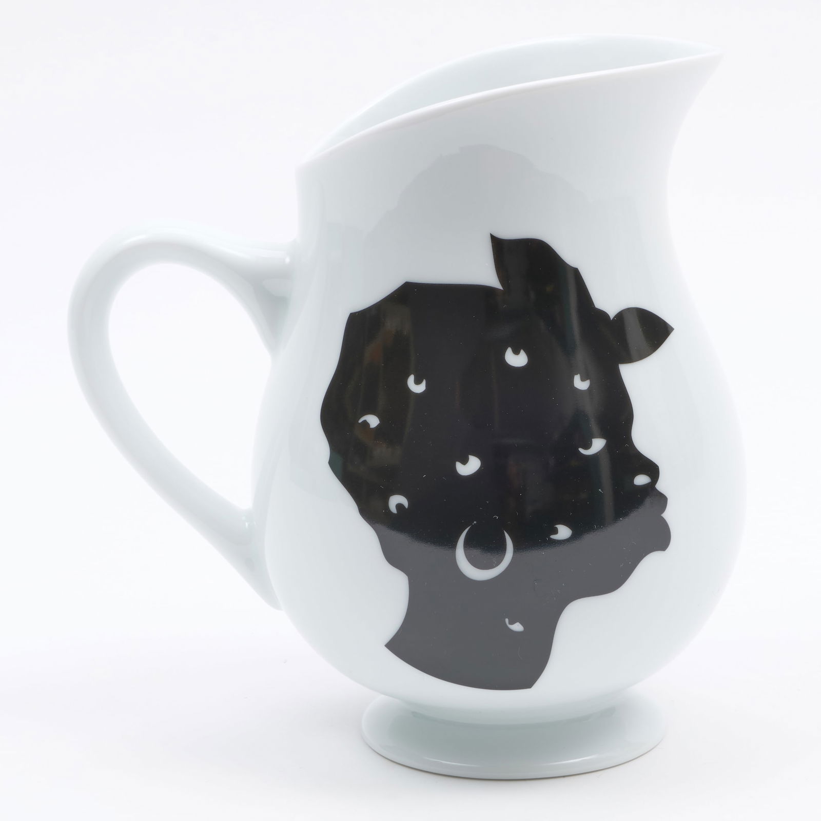 Kara Walker for Bernardaud Porcelain Pitcher: Kara Walker for Bernardaud Porcelain Pitcher Black printed mark, ed. 793/1000. 8 1/4 x 7 1/2 x 5 3/4 in. Property from the Jordan Saunders Collection