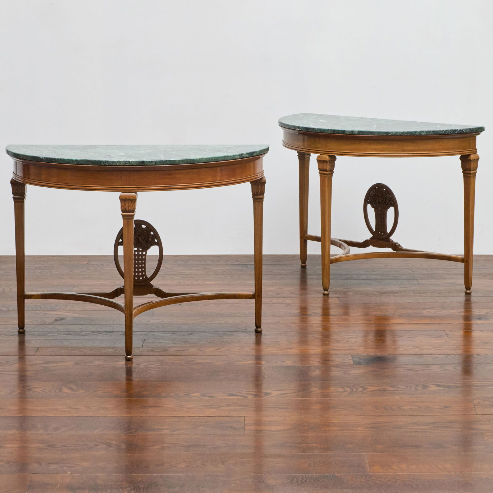 Pair of Demilune Faded Mahogany and Marble Top Console Tables, in the manner of Paul Follot: Pair of Demilune Faded Mahogany and Marble Top Console Tables, in the manner of Paul Follot Fitted with verde antico marble tops. 30 1/2 x 42 x 20 1/2 in. Jean Karajian Gallery.